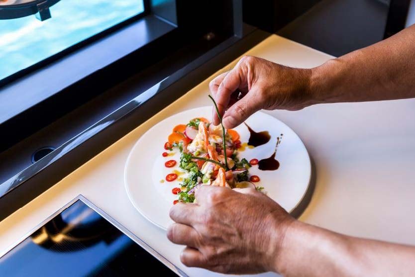 a person eating a plate of food aboard BARRACUDA III Yacht for Charter