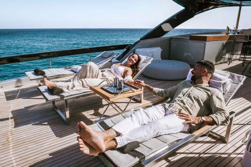 a group of people lying on a deck on a boat aboard BARRACUDA III Yacht for Charter