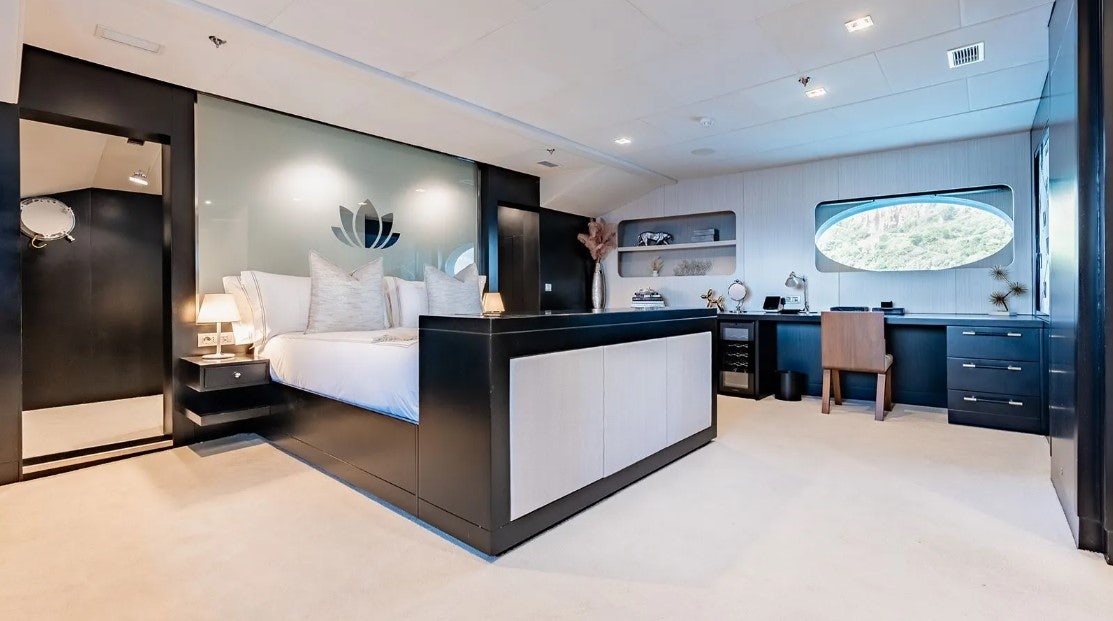 a room with a couch and a tv aboard LOTUS Yacht for Charter