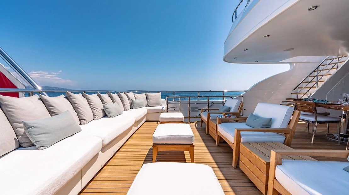 a large living room with a large balcony aboard LOTUS Yacht for Charter