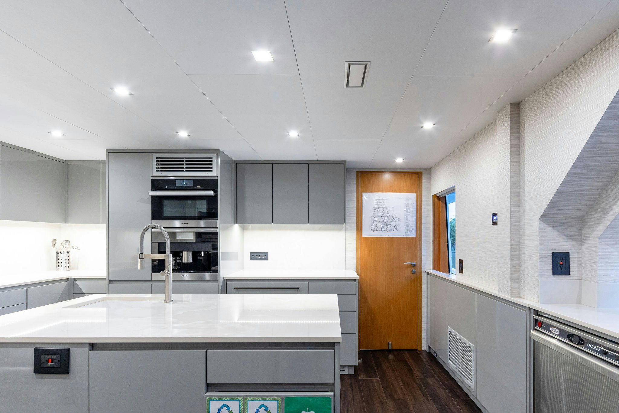 a kitchen with white cabinets aboard LAST CALL Yacht for Charter