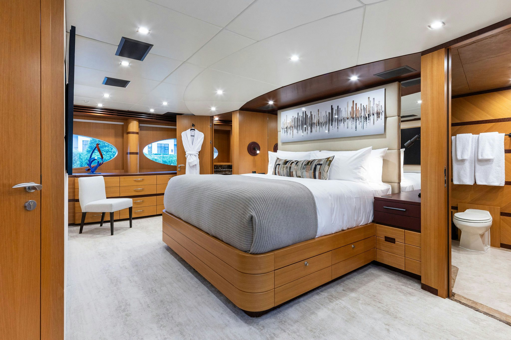 a bedroom with a bed and a mirror aboard LAST CALL Yacht for Charter