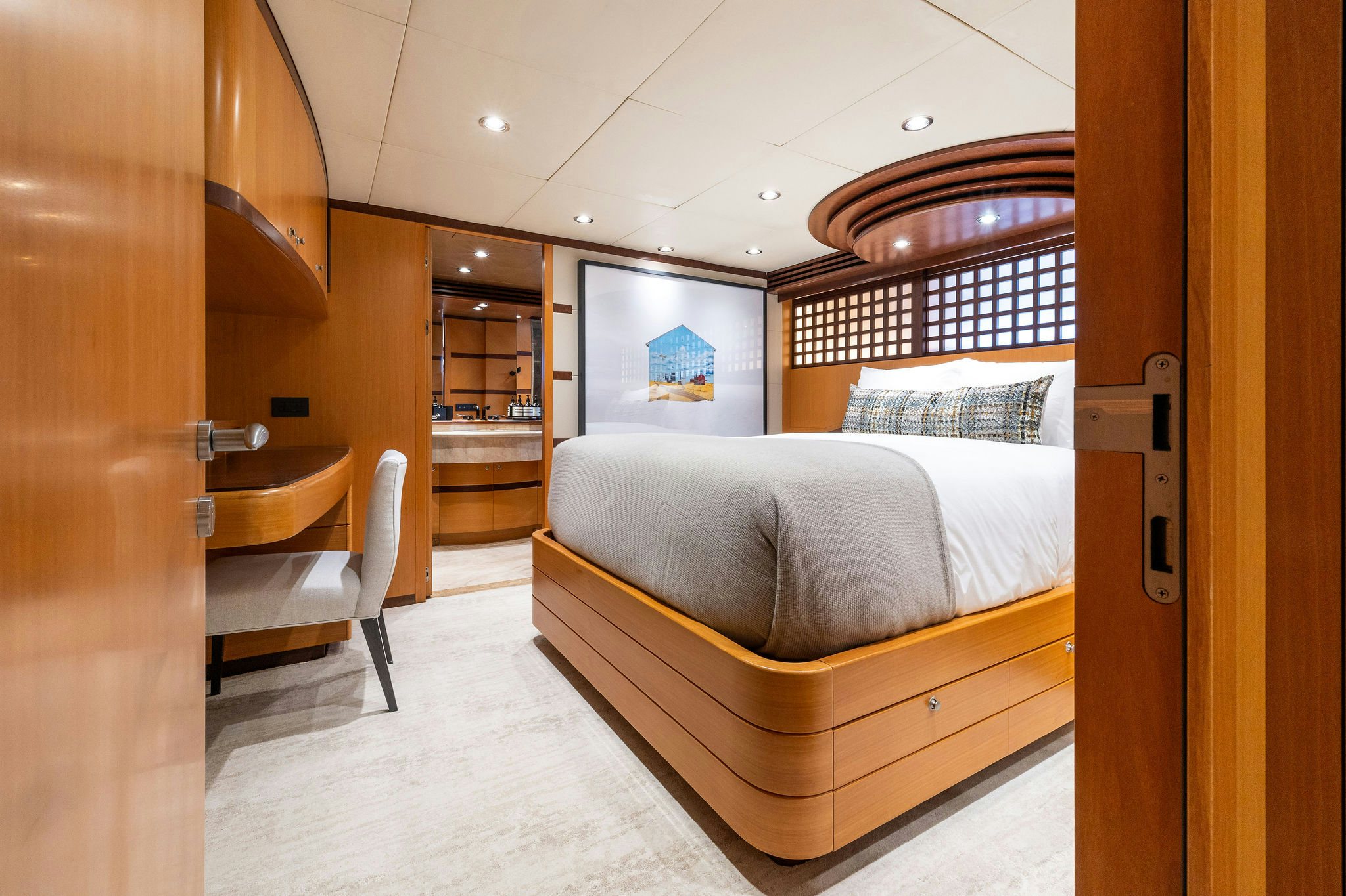 a bedroom with a bed and a desk aboard LAST CALL Yacht for Charter