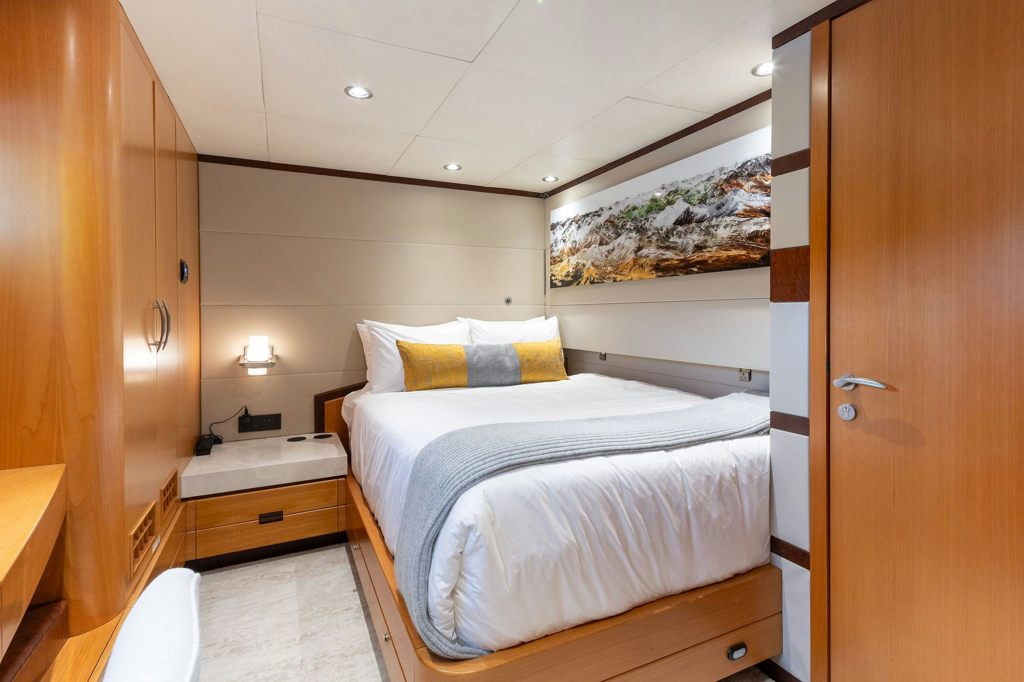 a bedroom with a bed and a wood door aboard LAST CALL Yacht for Charter
