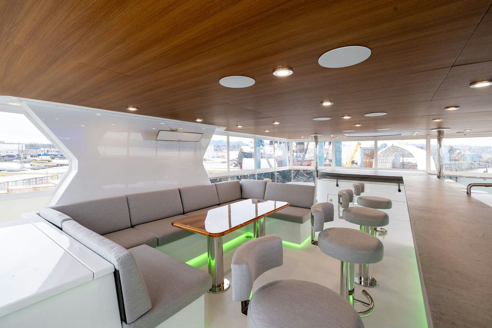 inside of a vehicle with tables and chairs and a large window aboard LAST CALL Yacht for Charter