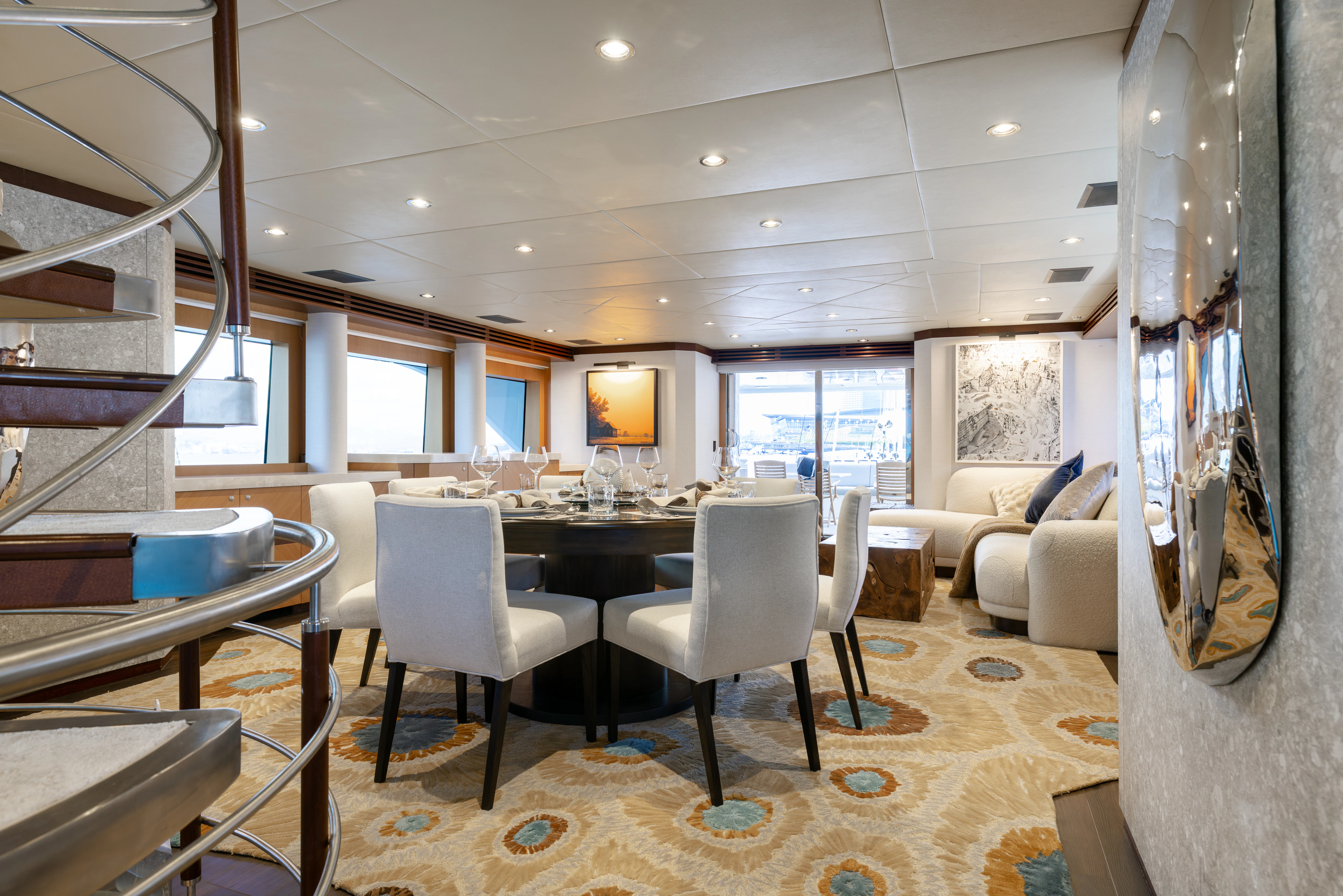 a room with a table chairs and a tv aboard LAST CALL Yacht for Charter