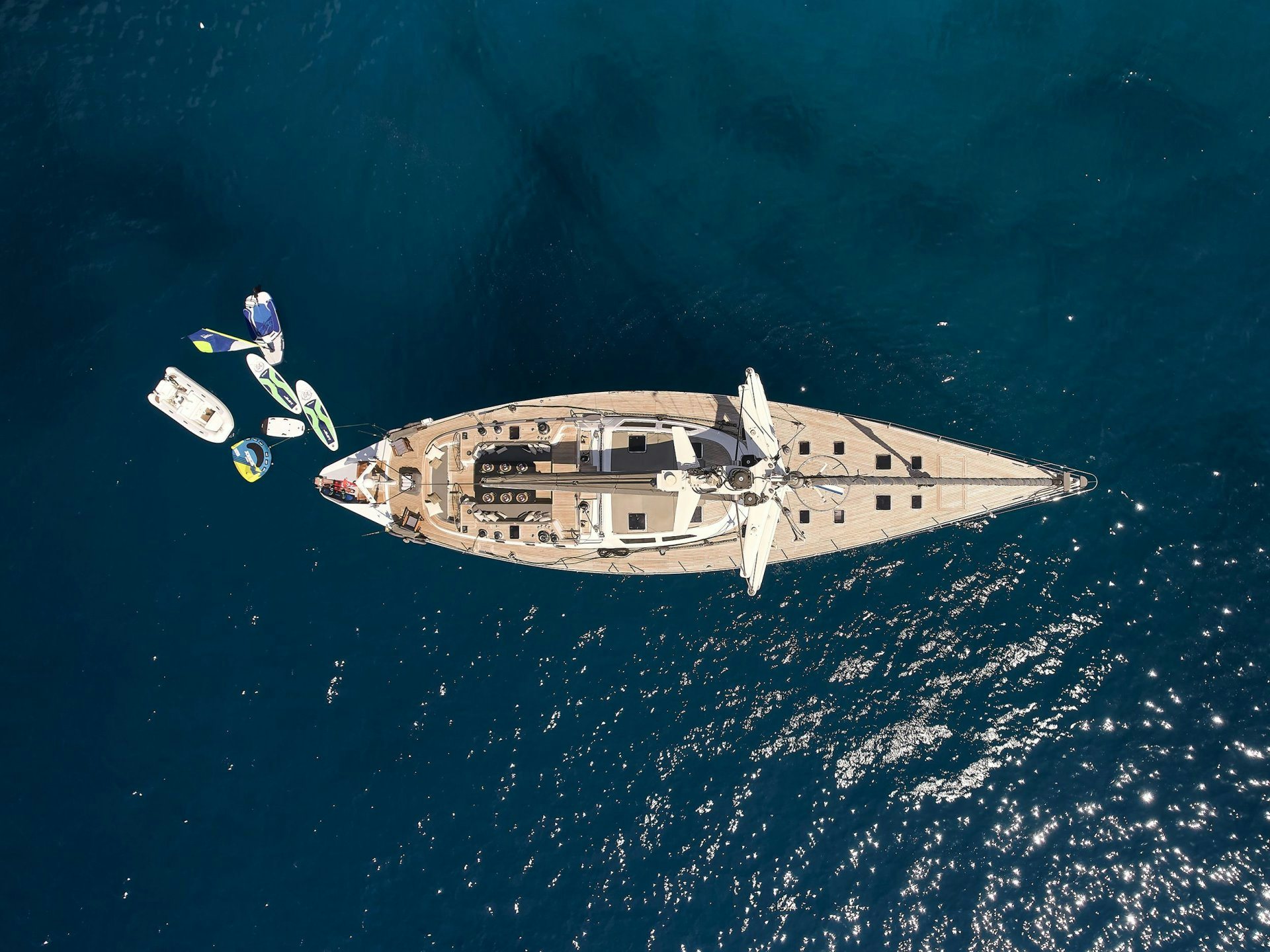 a person in a space suit flying over a ship in the ocean aboard AIZU Yacht for Sale