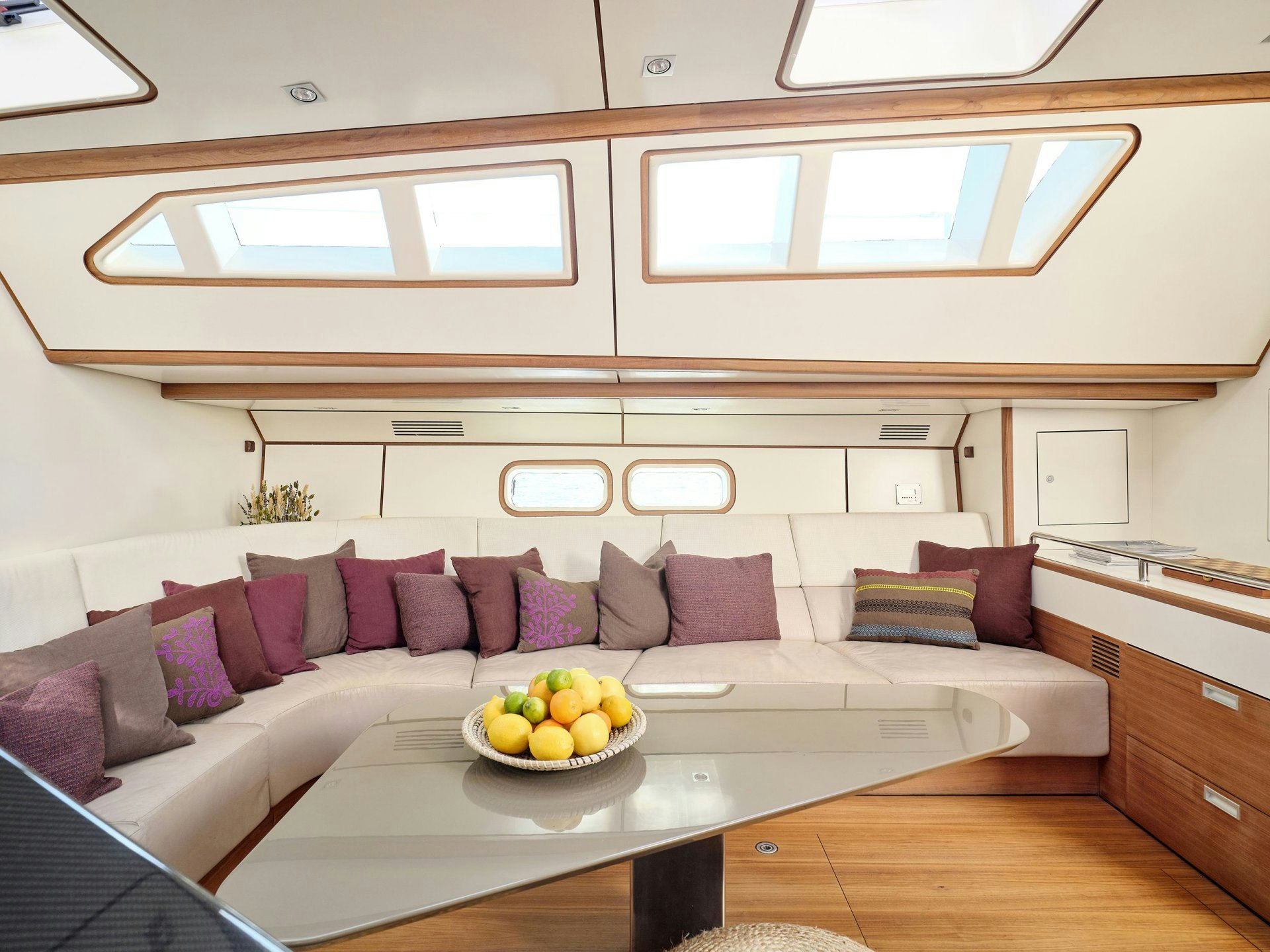 a couch and a table in a room aboard AIZU Yacht for Sale