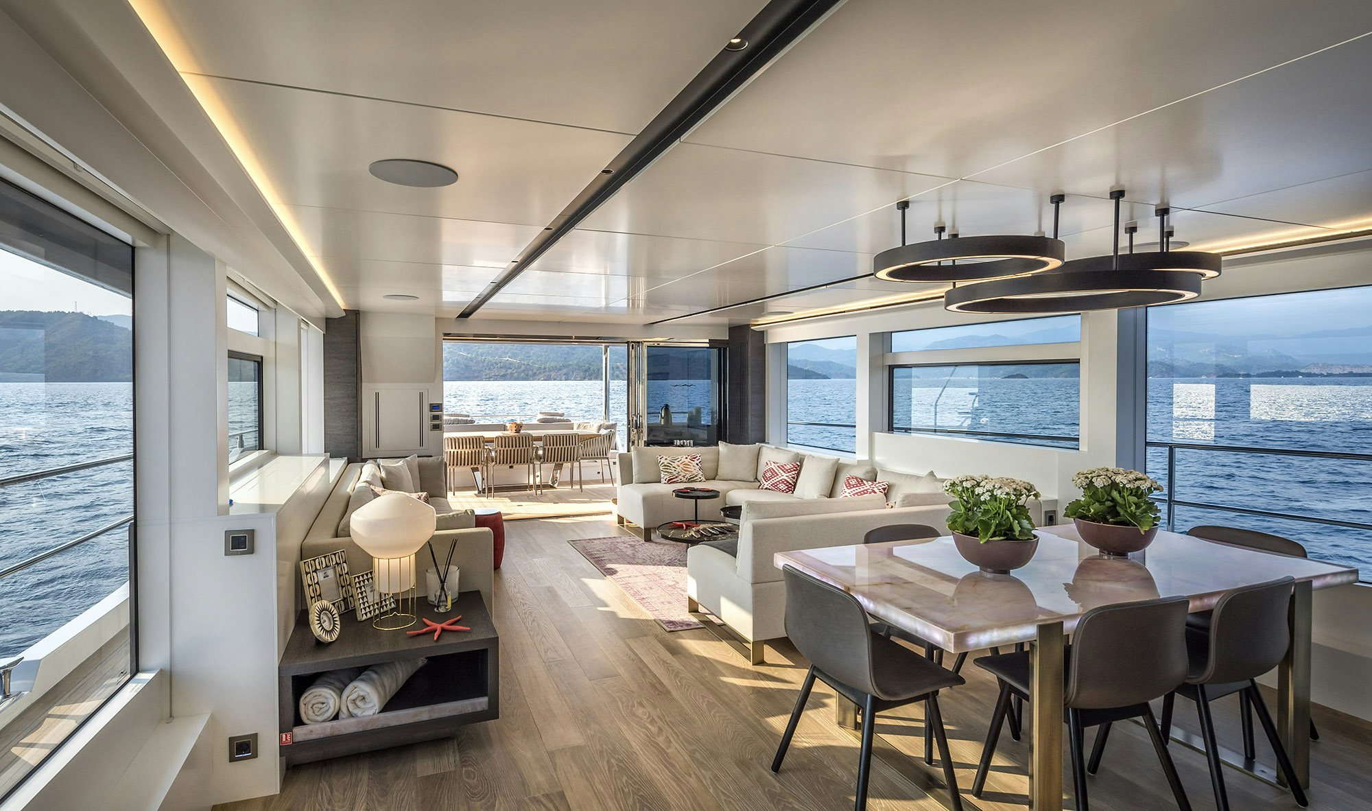 a living room with a large table and chairs aboard NUMARINE 26XP/25 Yacht for Sale