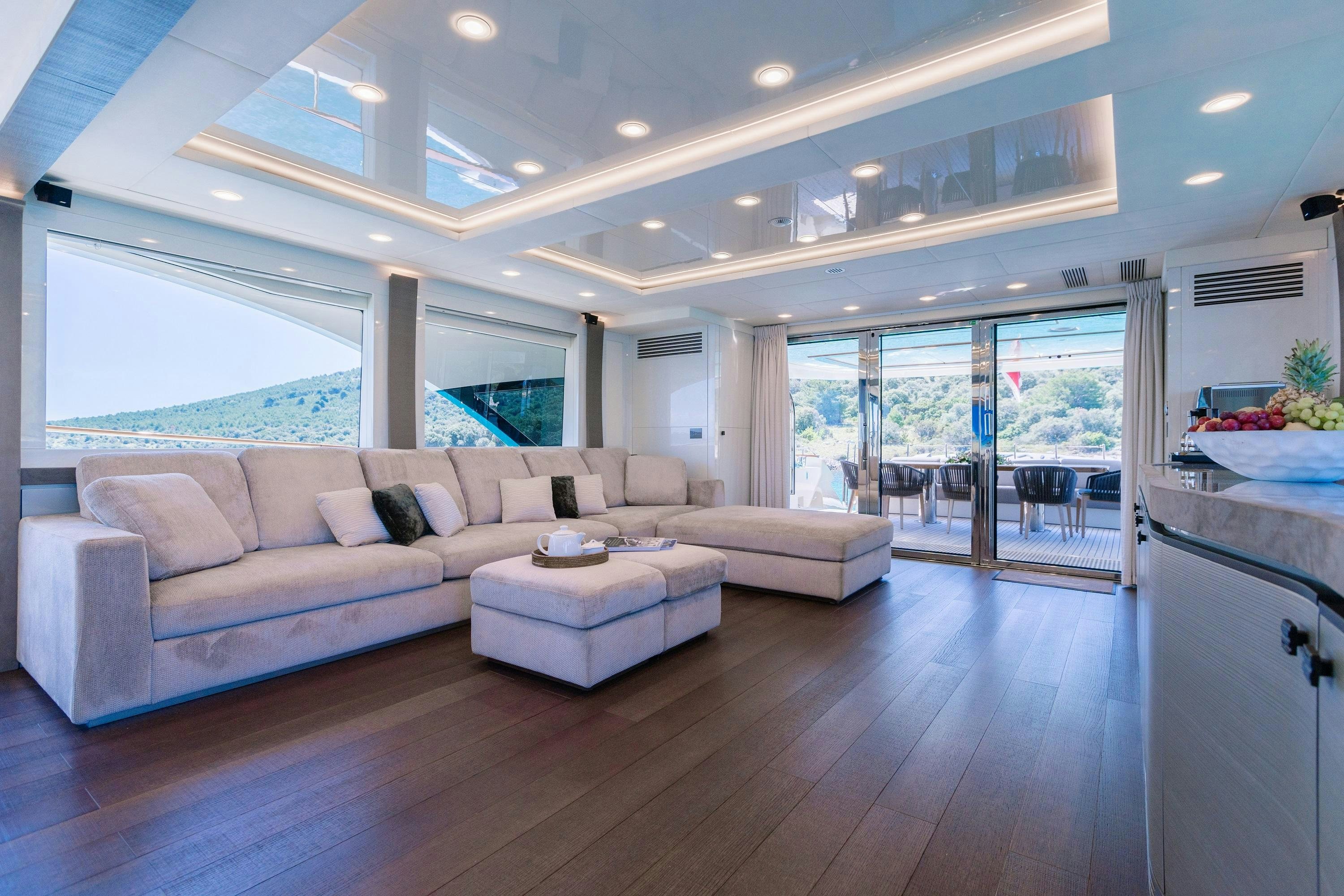 a living room with a large window aboard VIVALDI Yacht for Charter