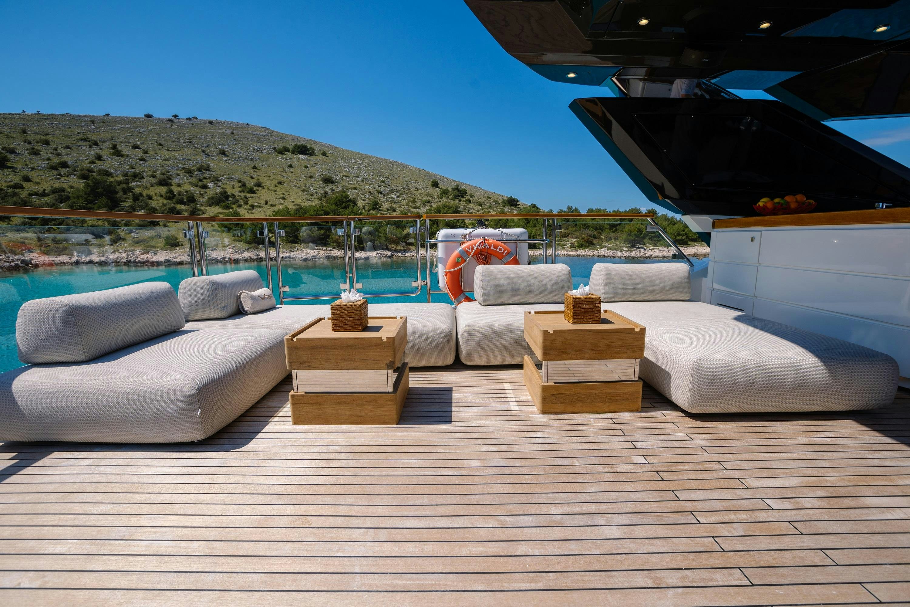 a deck with a pool and a deck with a large rock wall aboard VIVALDI Yacht for Charter