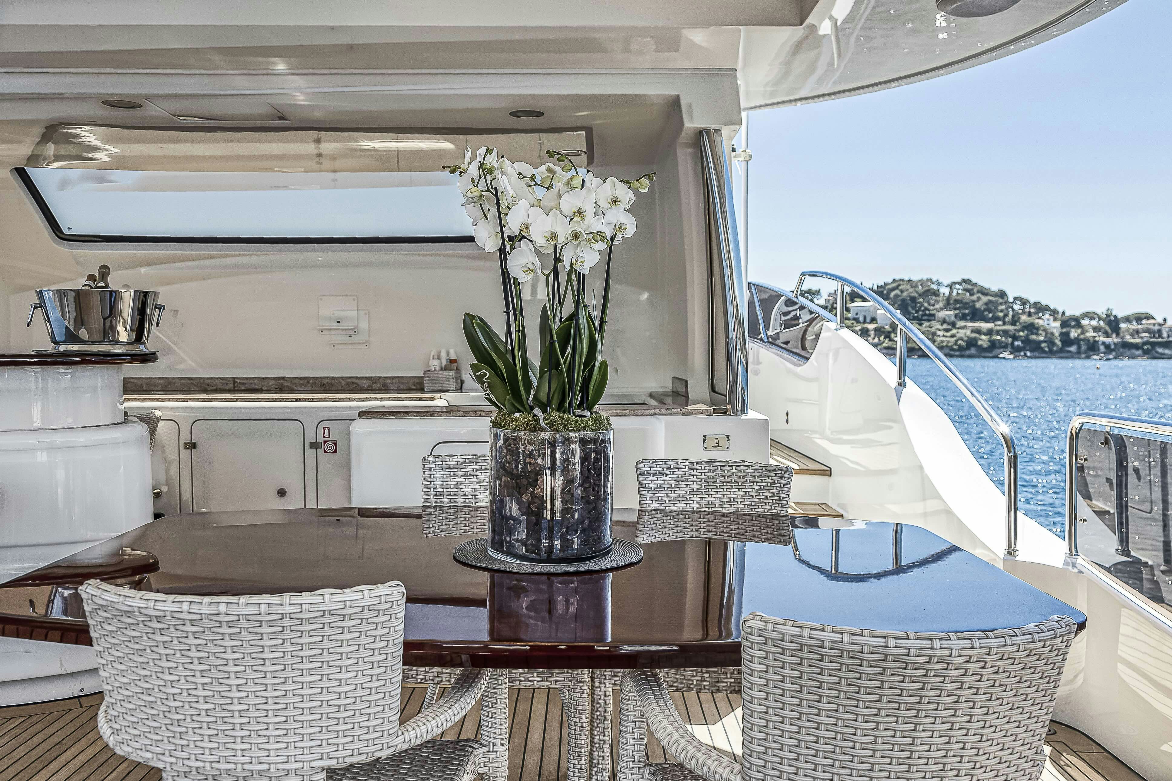 a vase of flowers on a table aboard ROSE OF KINGSTON II Yacht for Sale