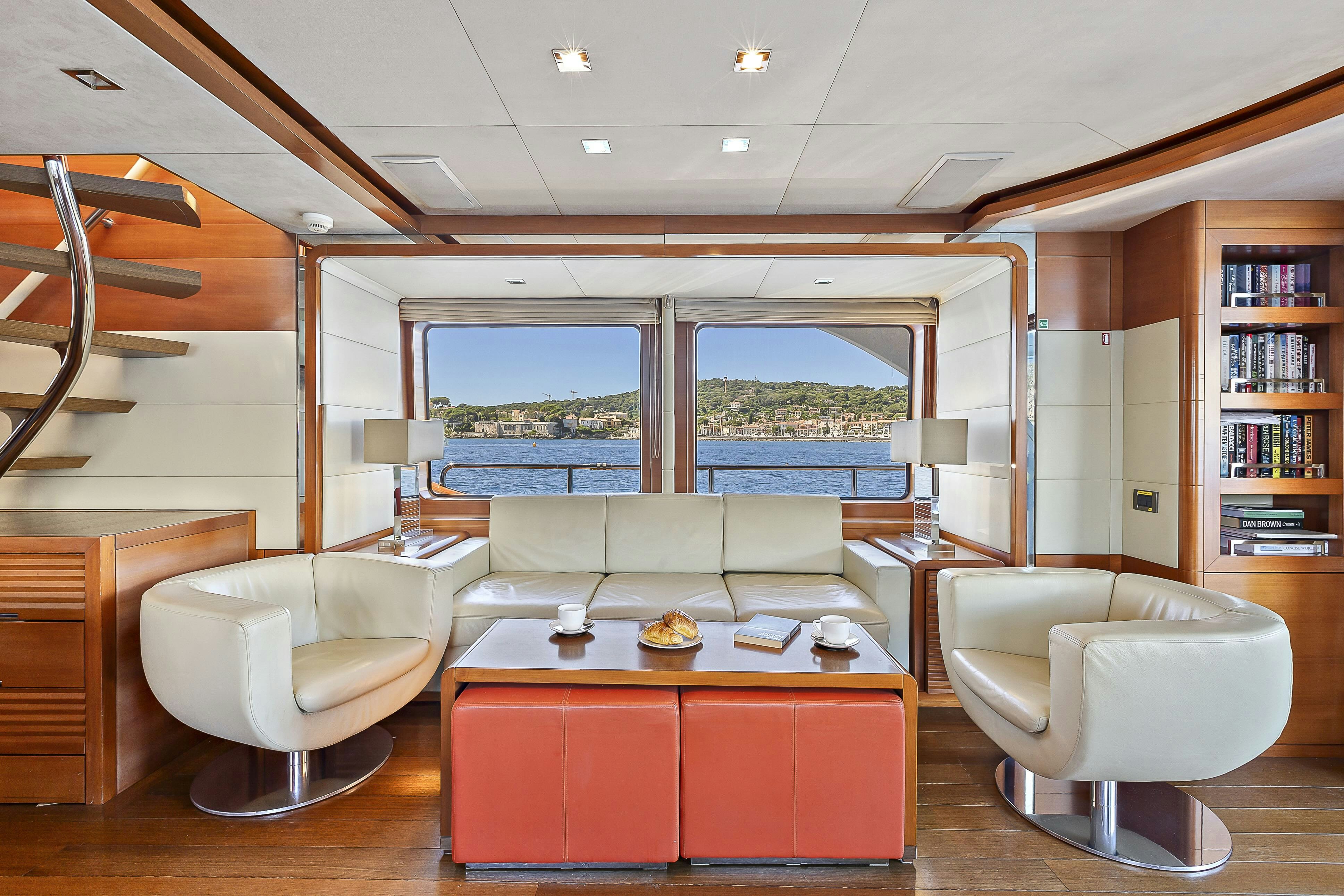 a room with a table chairs and a window aboard ROSE OF KINGSTON II Yacht for Sale