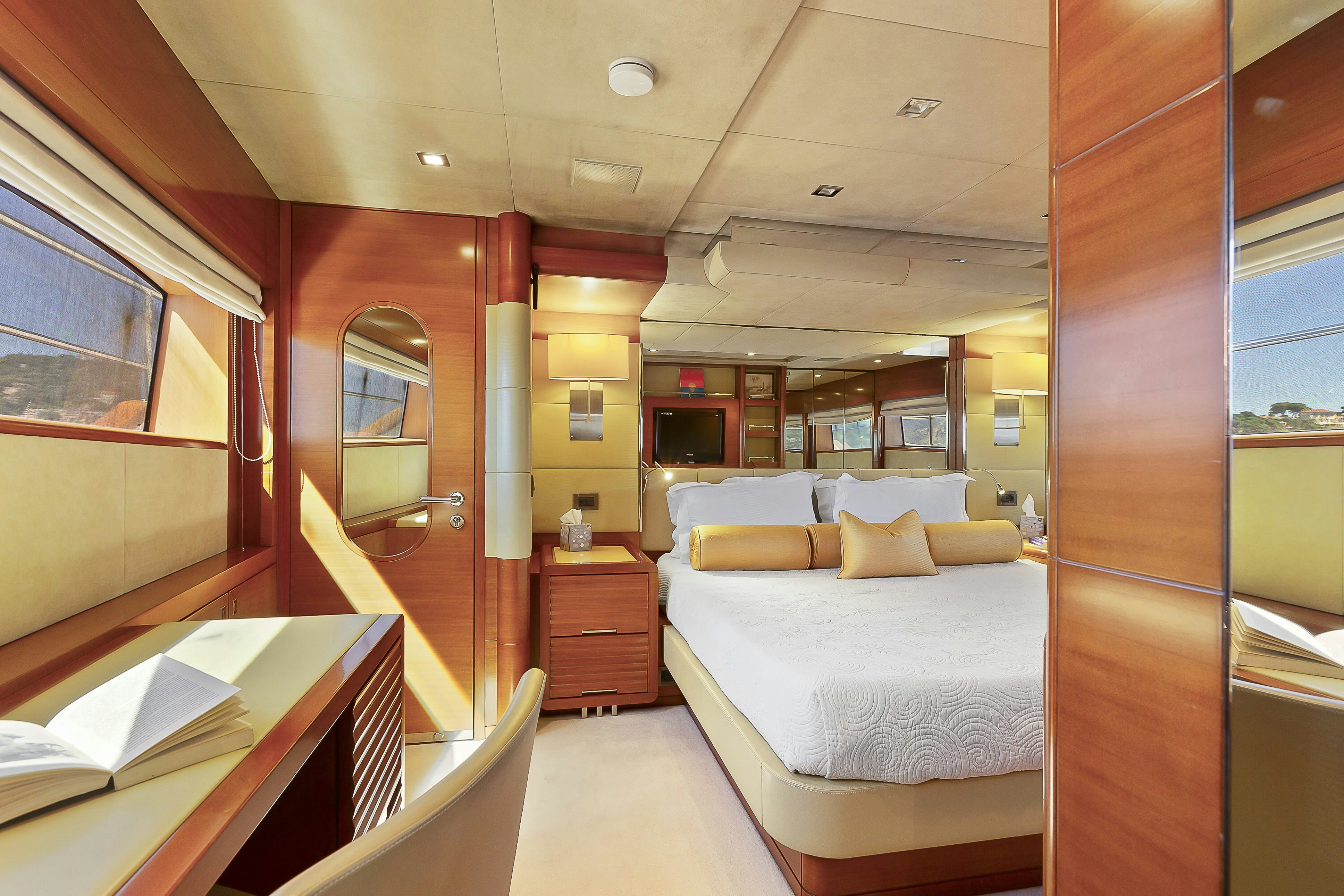 a room with a bed and a desk aboard ROSE OF KINGSTON II Yacht for Sale