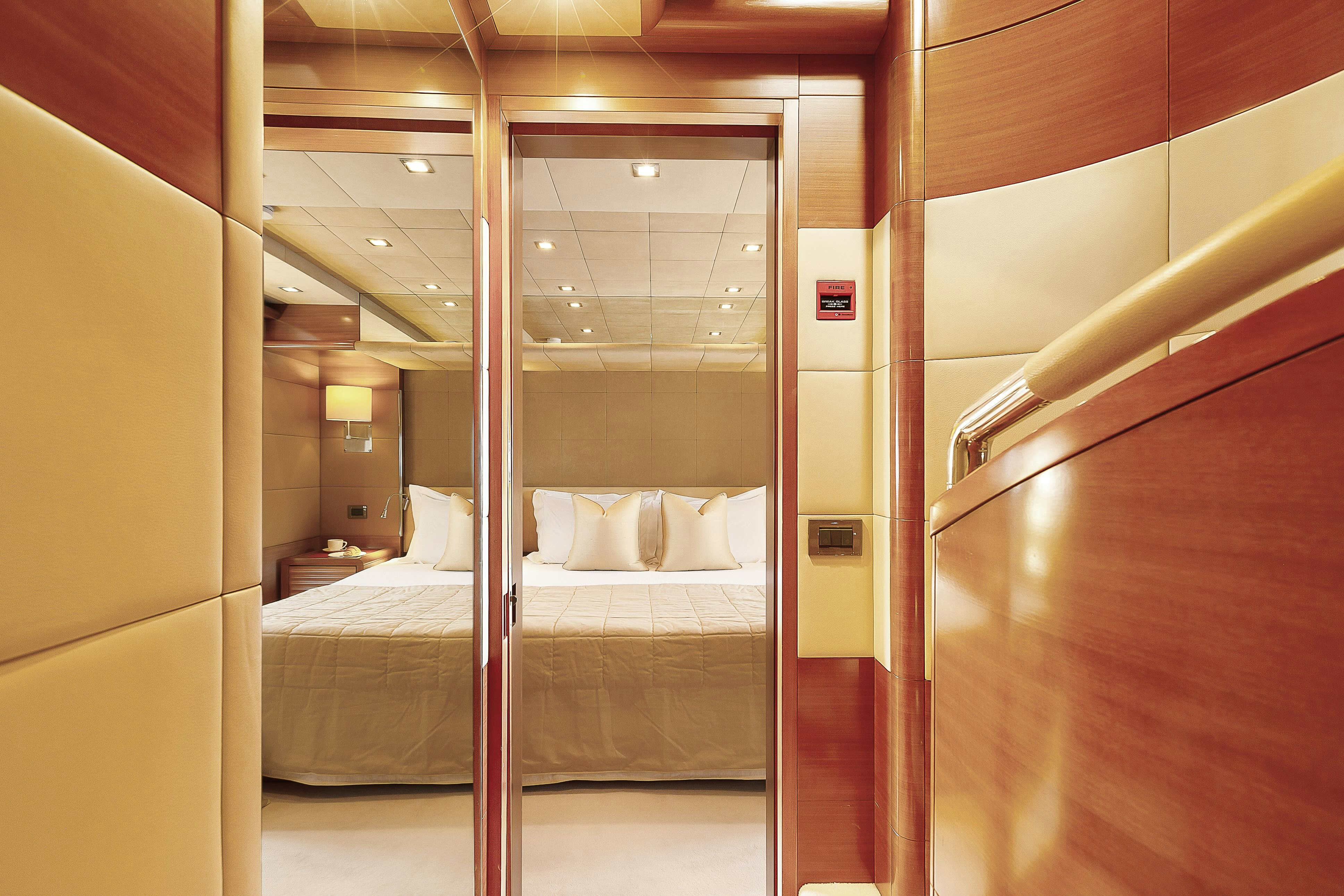 a room with a bed and a mirror aboard ROSE OF KINGSTON II Yacht for Sale