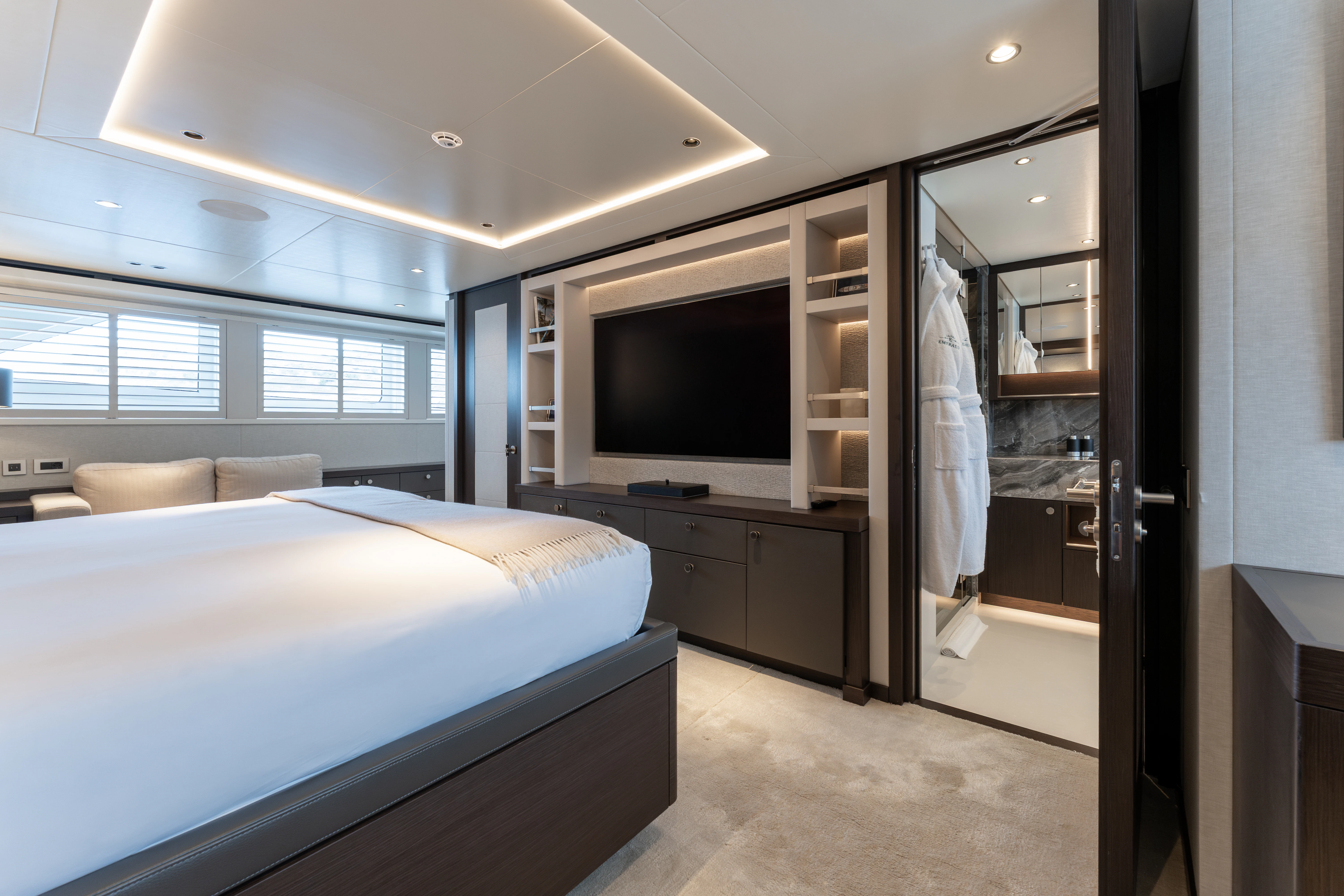 a bedroom with a bed and a tv aboard EMERALD Yacht for Charter