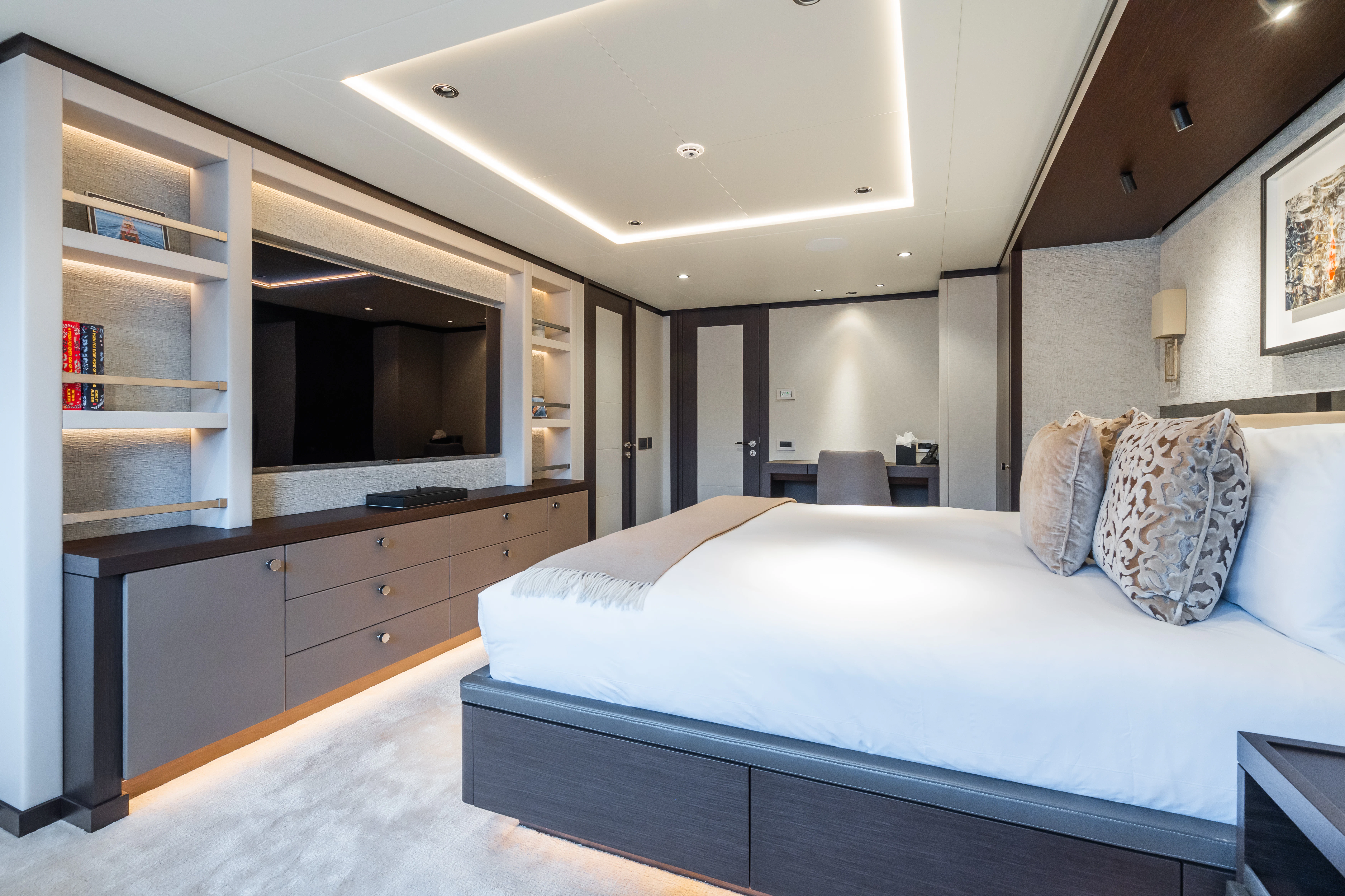 a bedroom with a bed and a television aboard EMERALD Yacht for Charter