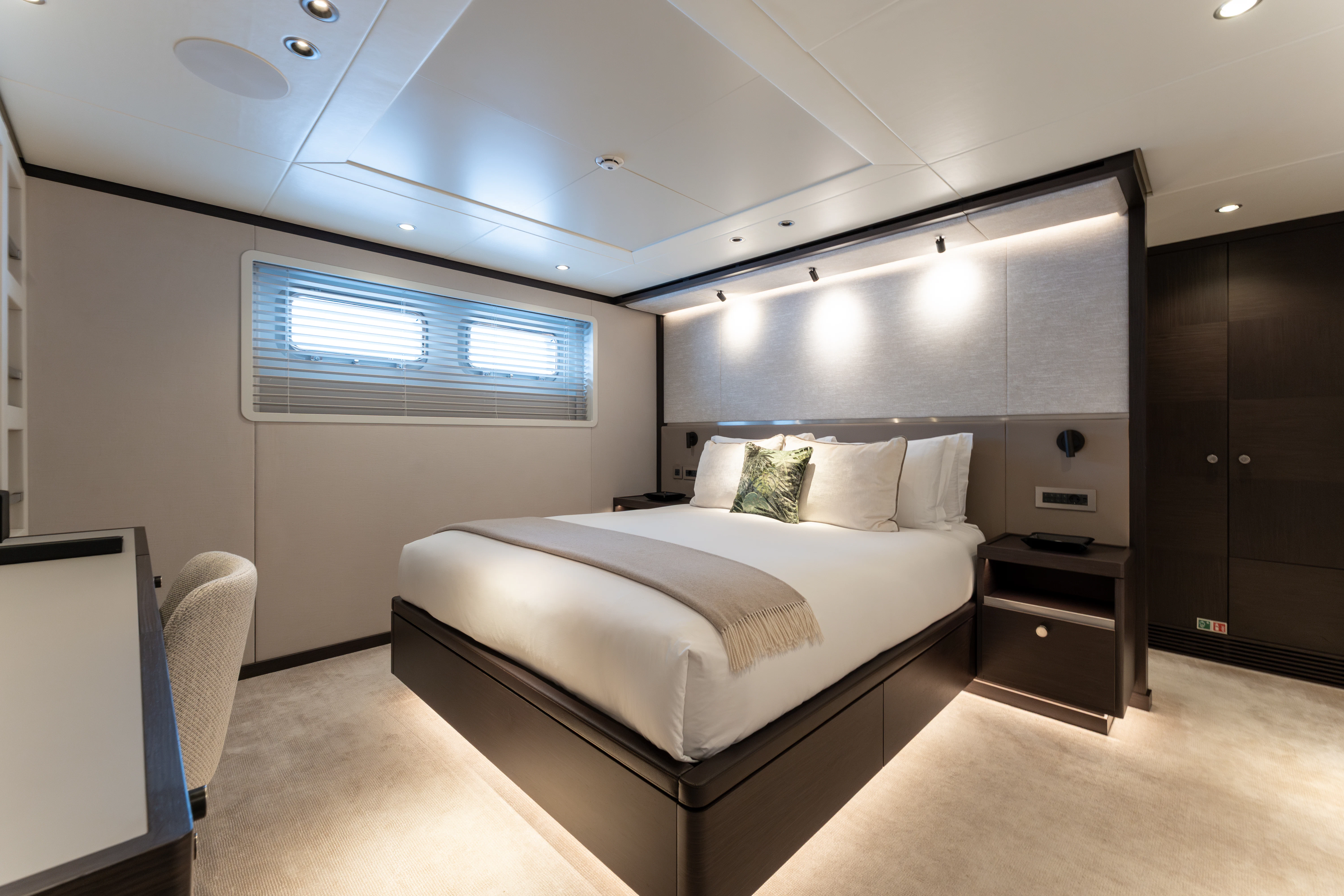 a room with a bed and a desk aboard EMERALD Yacht for Charter