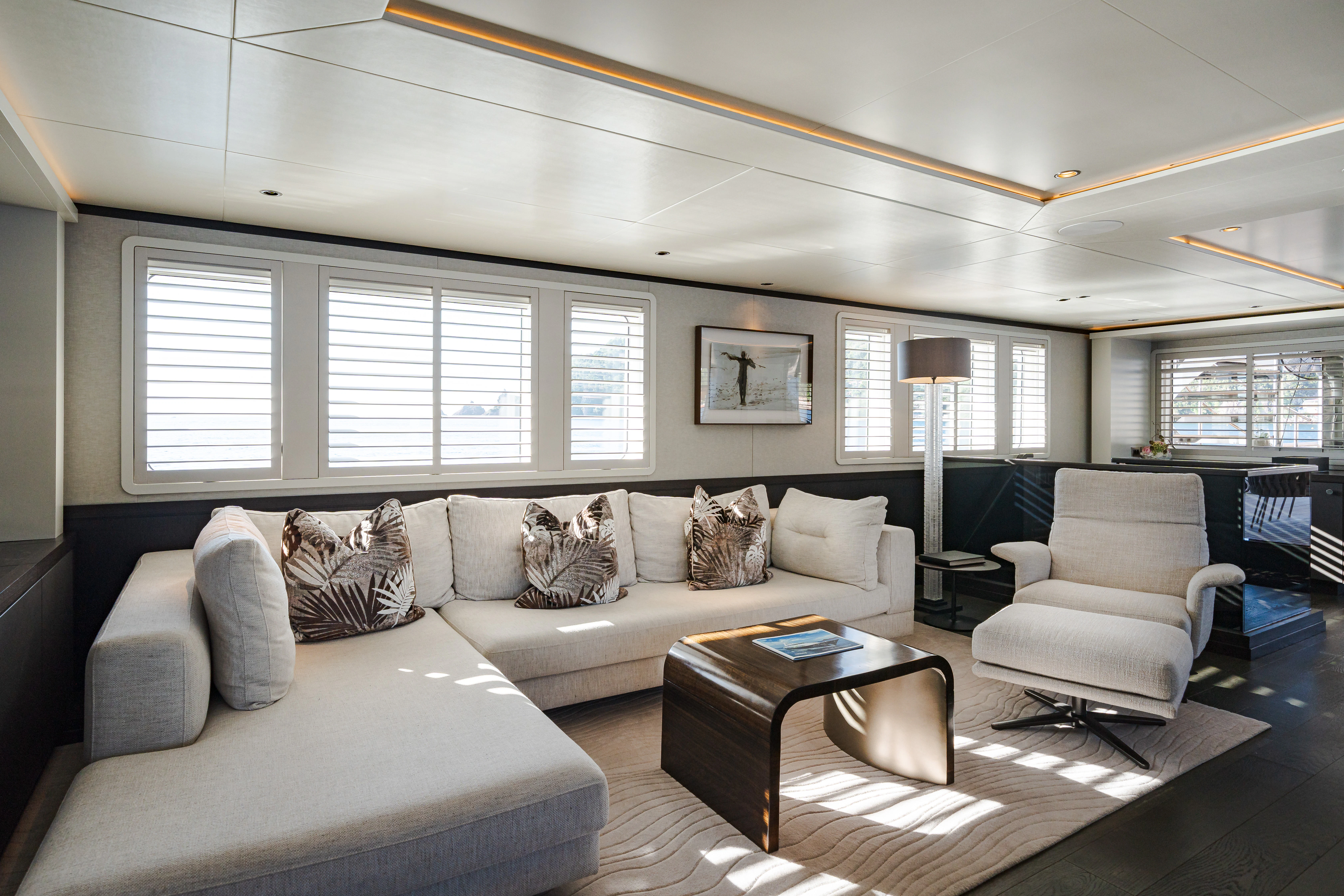 a living room with a couch and a coffee table aboard EMERALD Yacht for Sale
