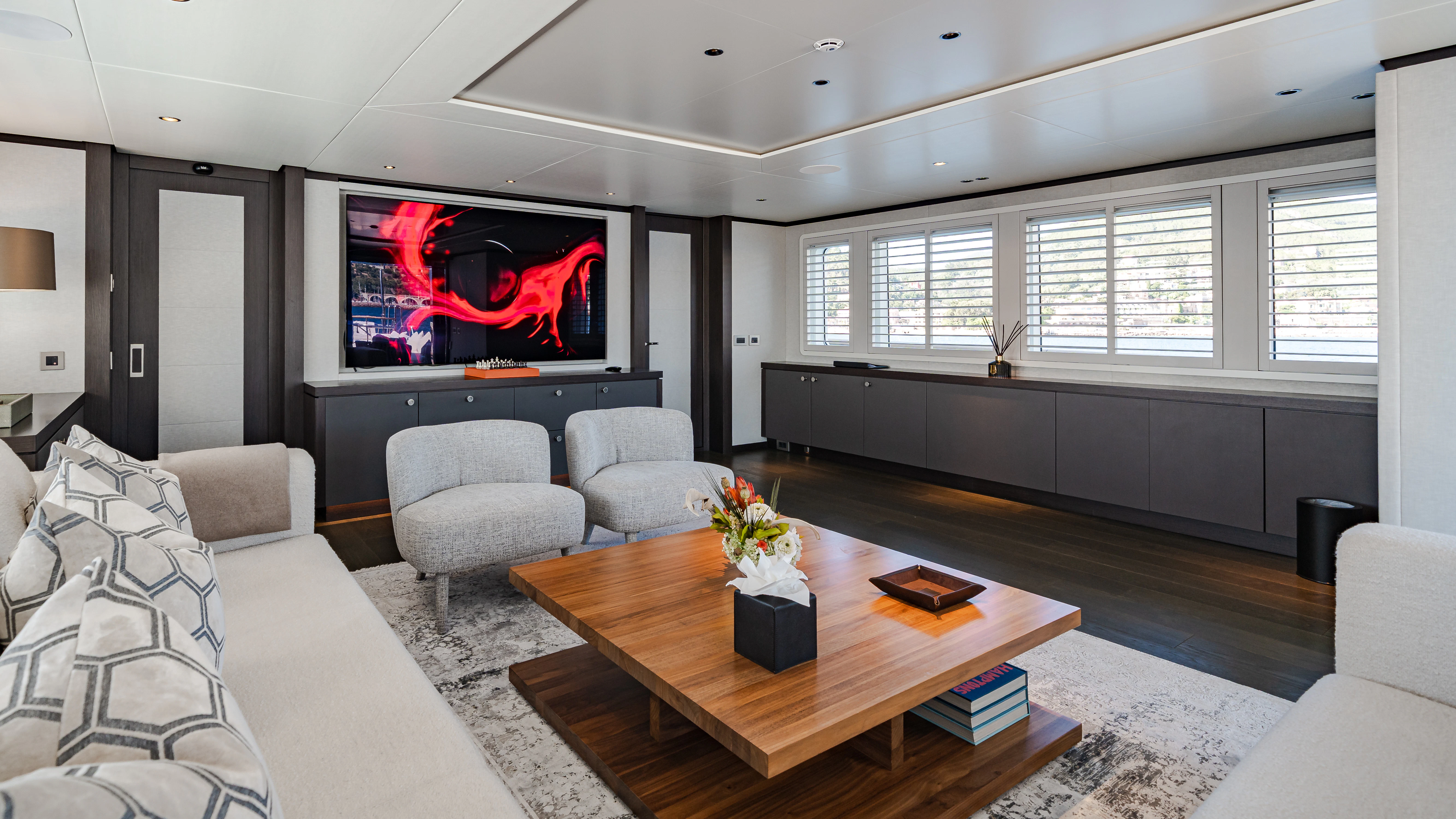 a living room with a tv and couches aboard EMERALD Yacht for Sale