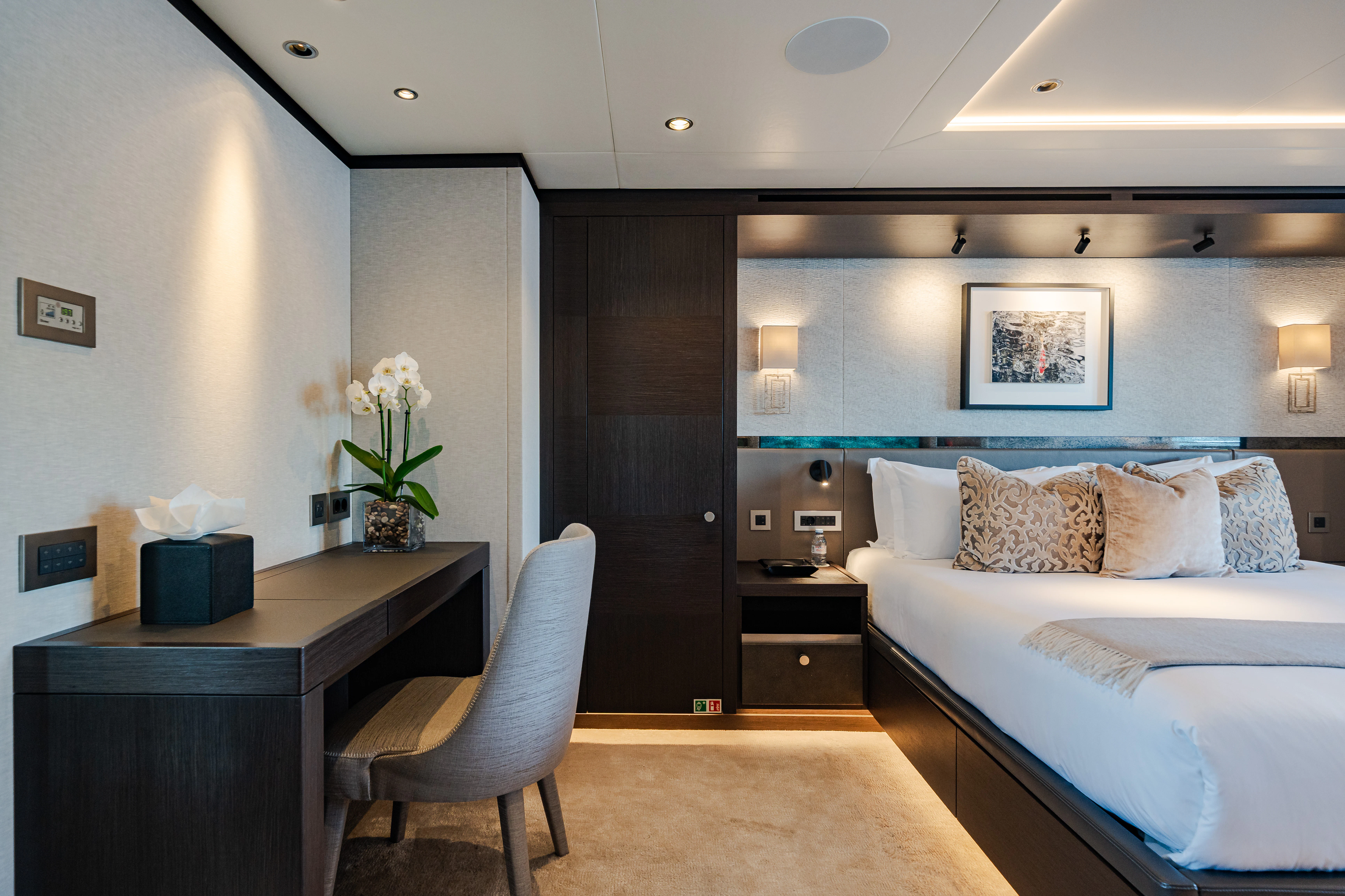 a bedroom with a bed and desk aboard EMERALD Yacht for Sale