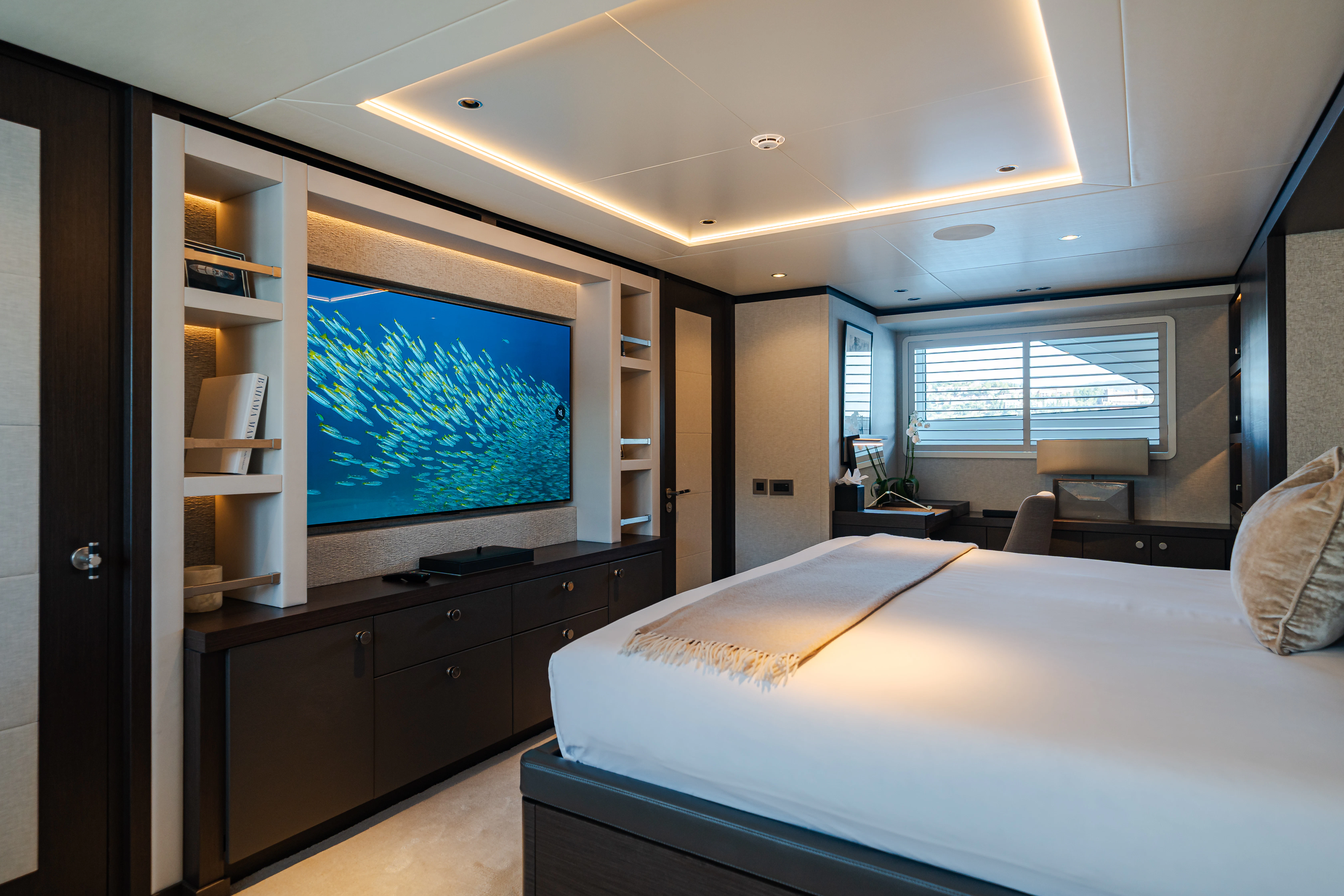 a bedroom with a large tv aboard EMERALD Yacht for Sale