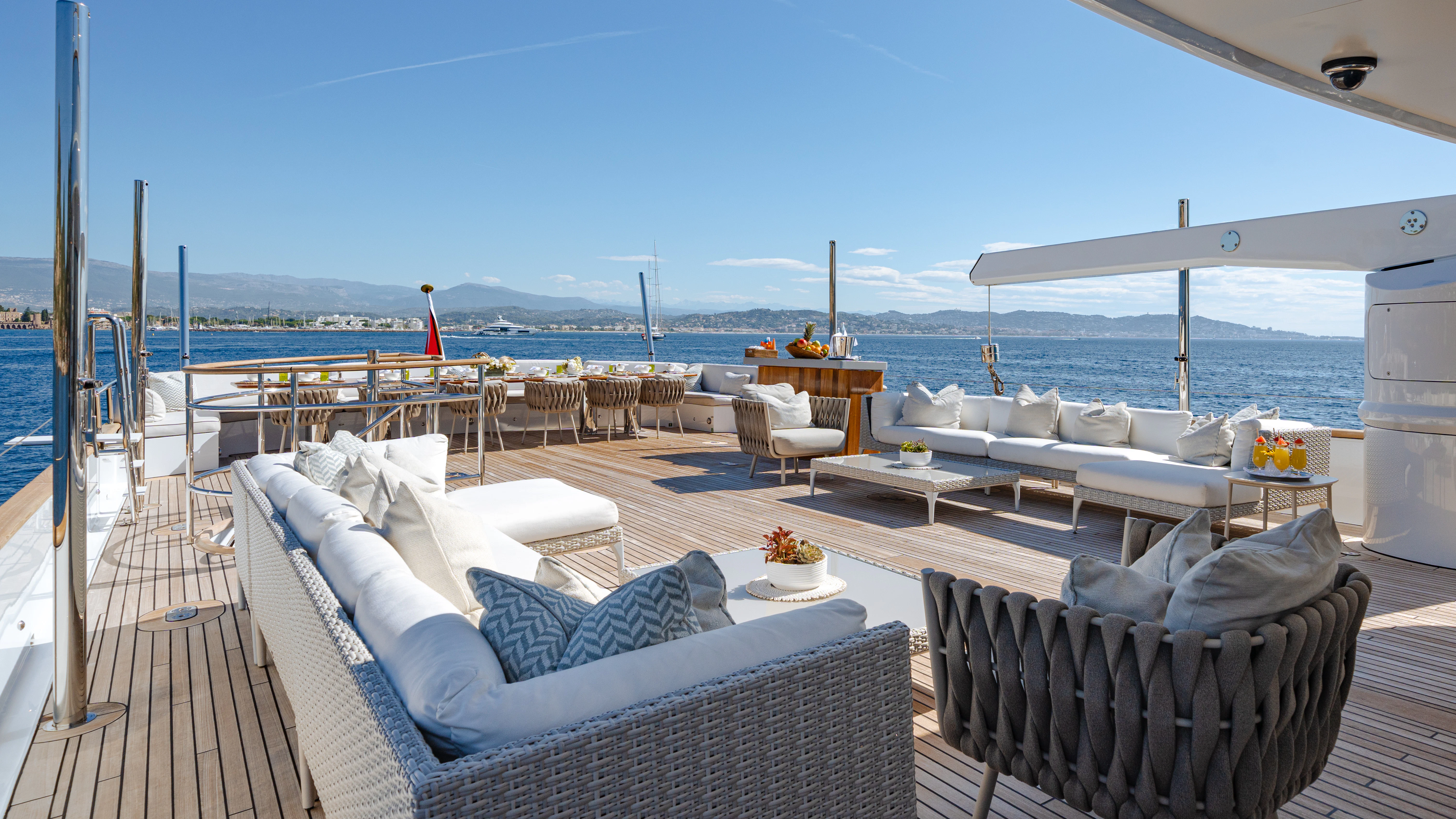 a patio with a large body of water in the background aboard EMERALD Yacht for Sale
