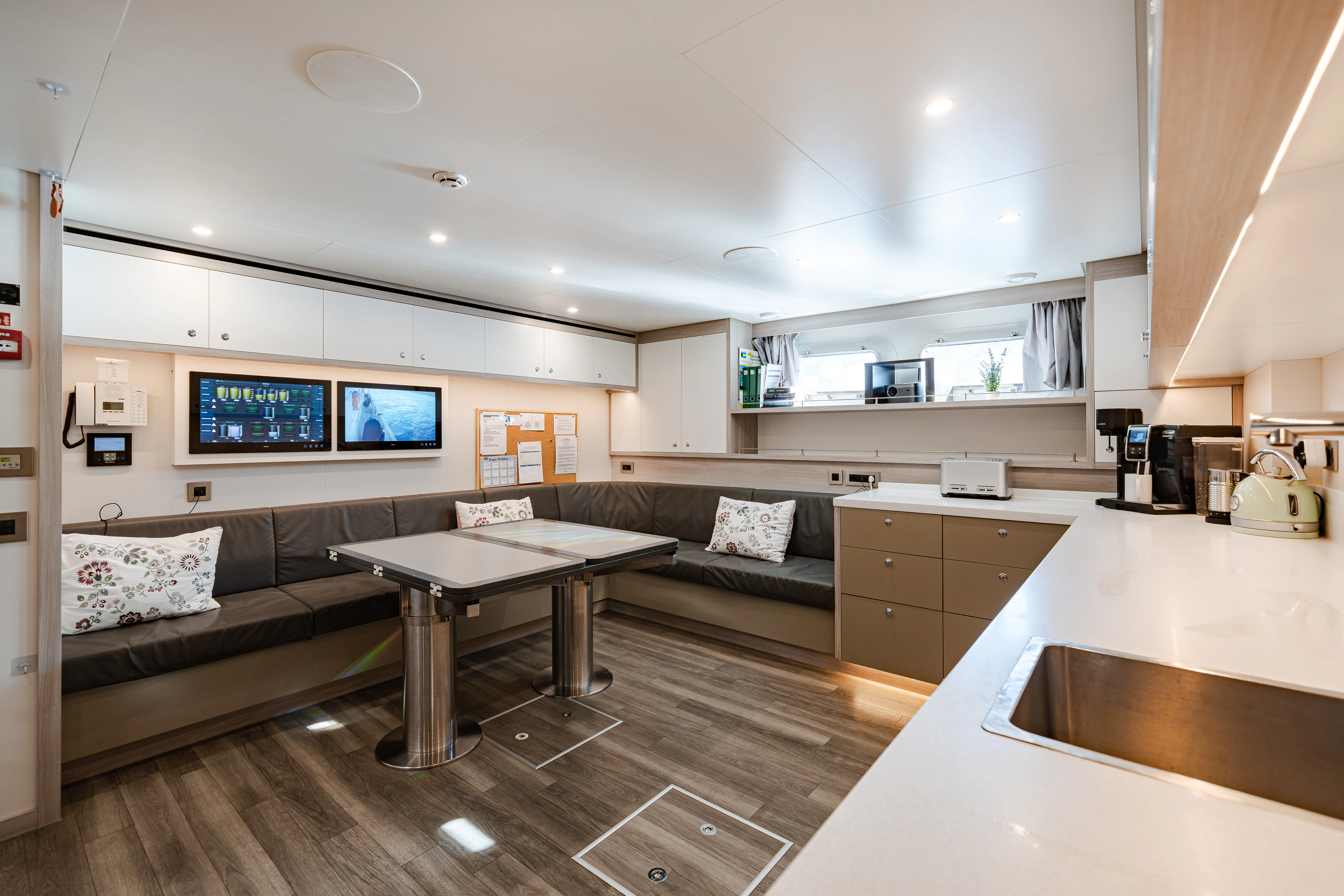 a living room with a couch and a table aboard EMERALD Yacht for Sale
