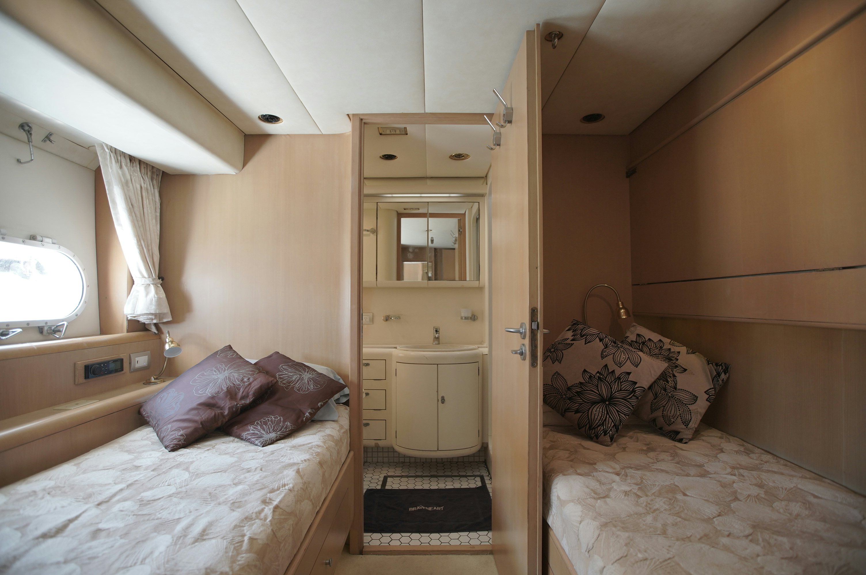 a bedroom with a double bed aboard BRAVEHEART 2 Yacht for Sale