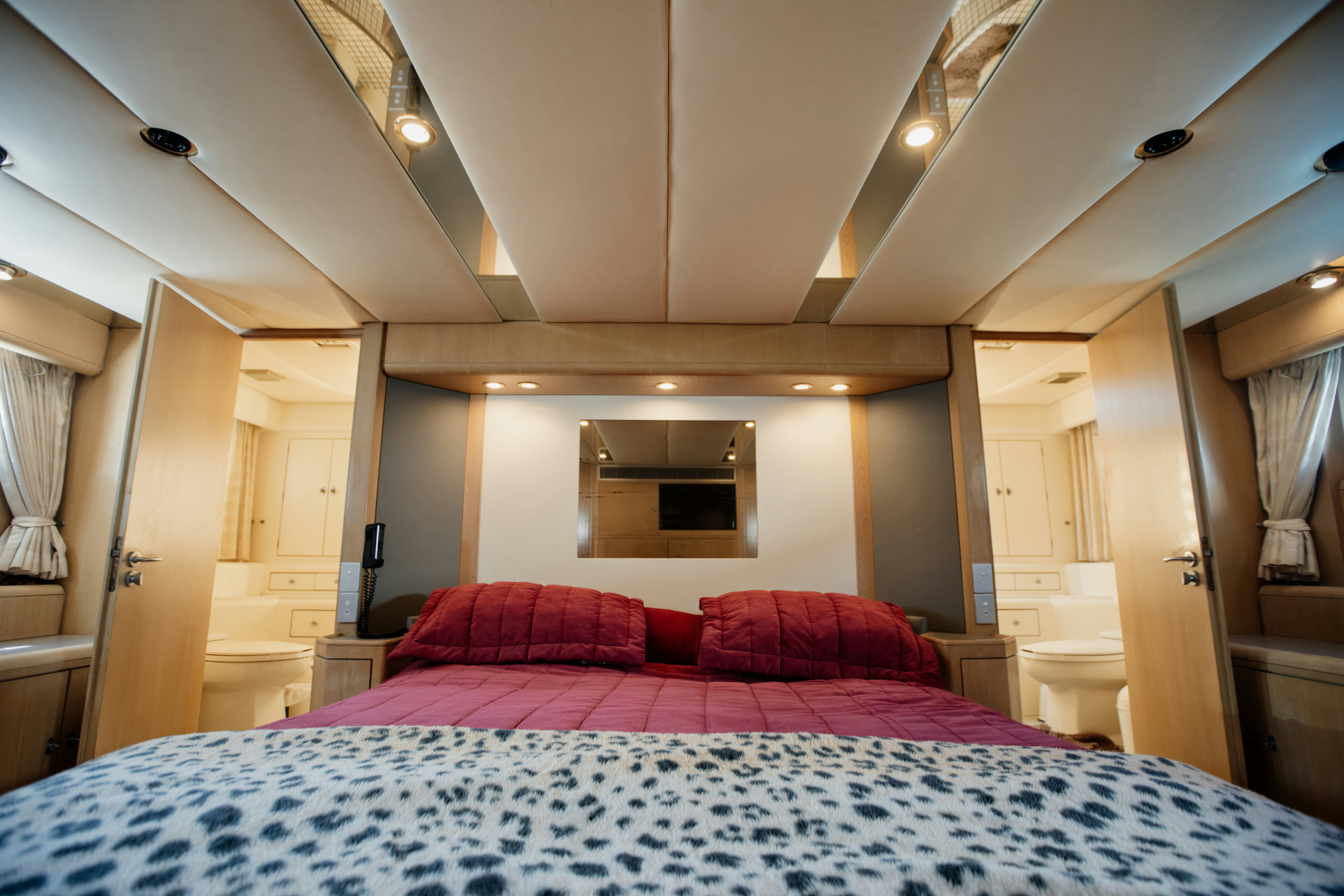 a bed with red sheets aboard BRAVEHEART 2 Yacht for Sale