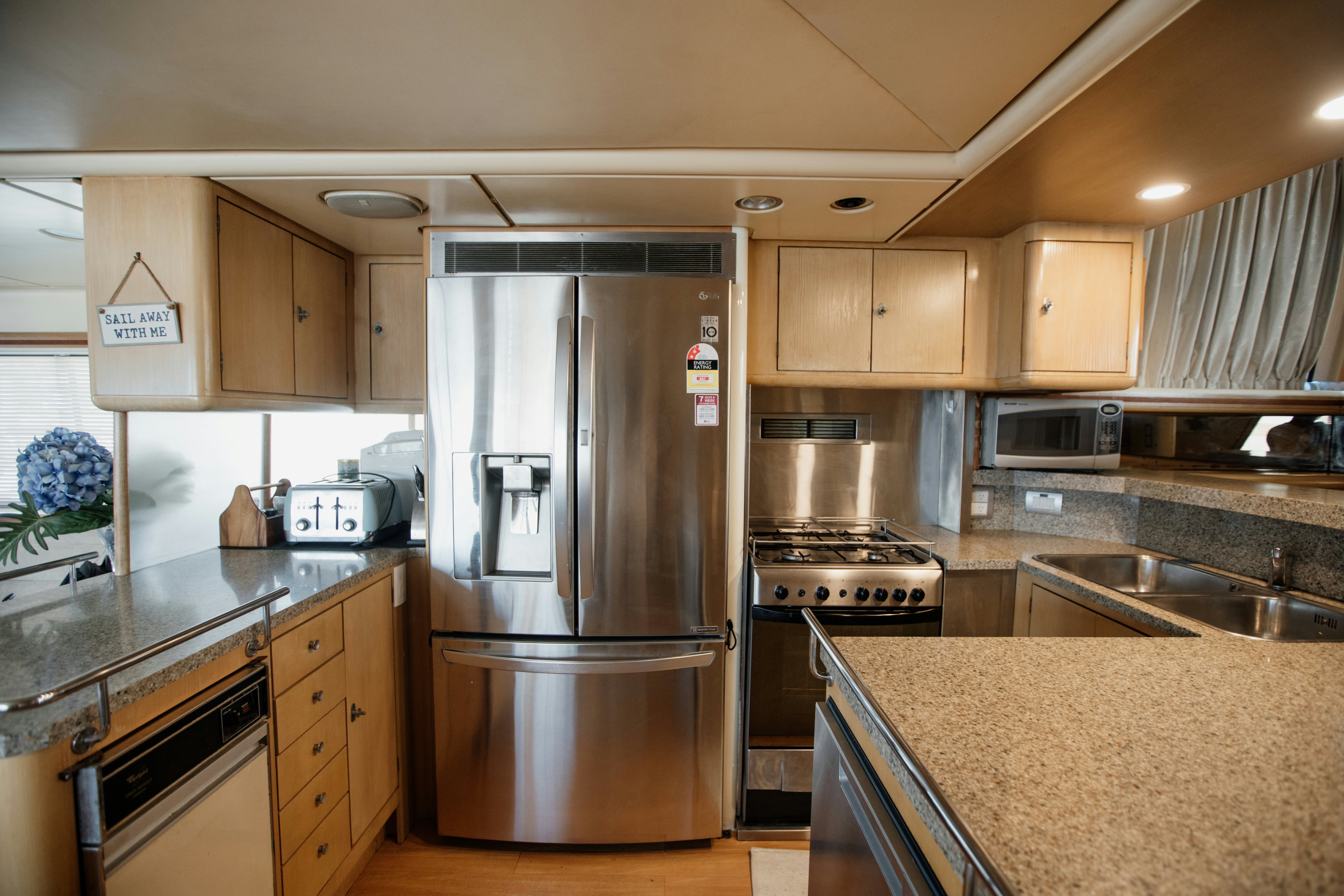 a kitchen with a stainless steel refrigerator aboard BRAVEHEART 2 Yacht for Sale