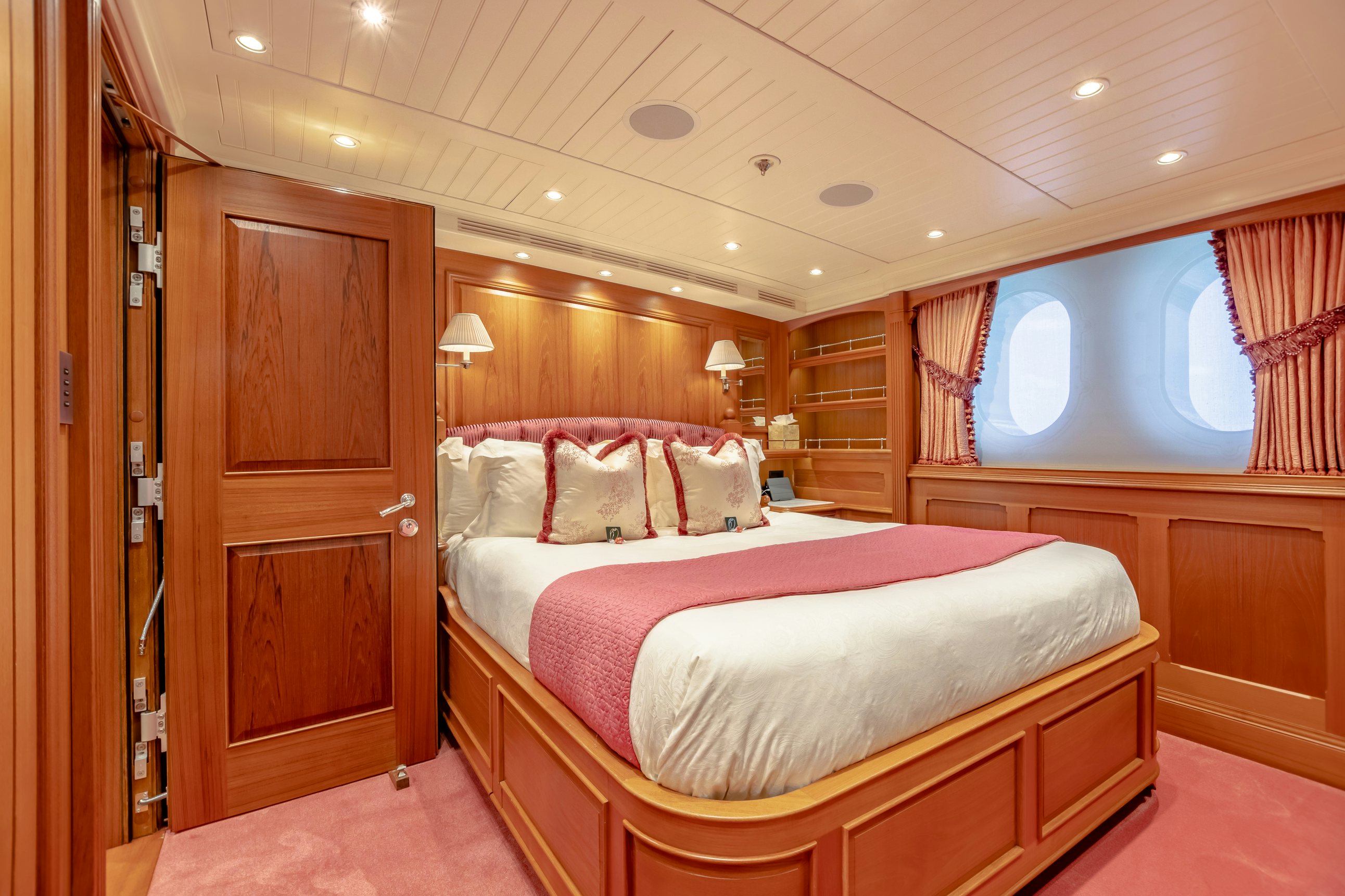 a bedroom with a bed and a closet aboard SHADOWL Yacht for Charter