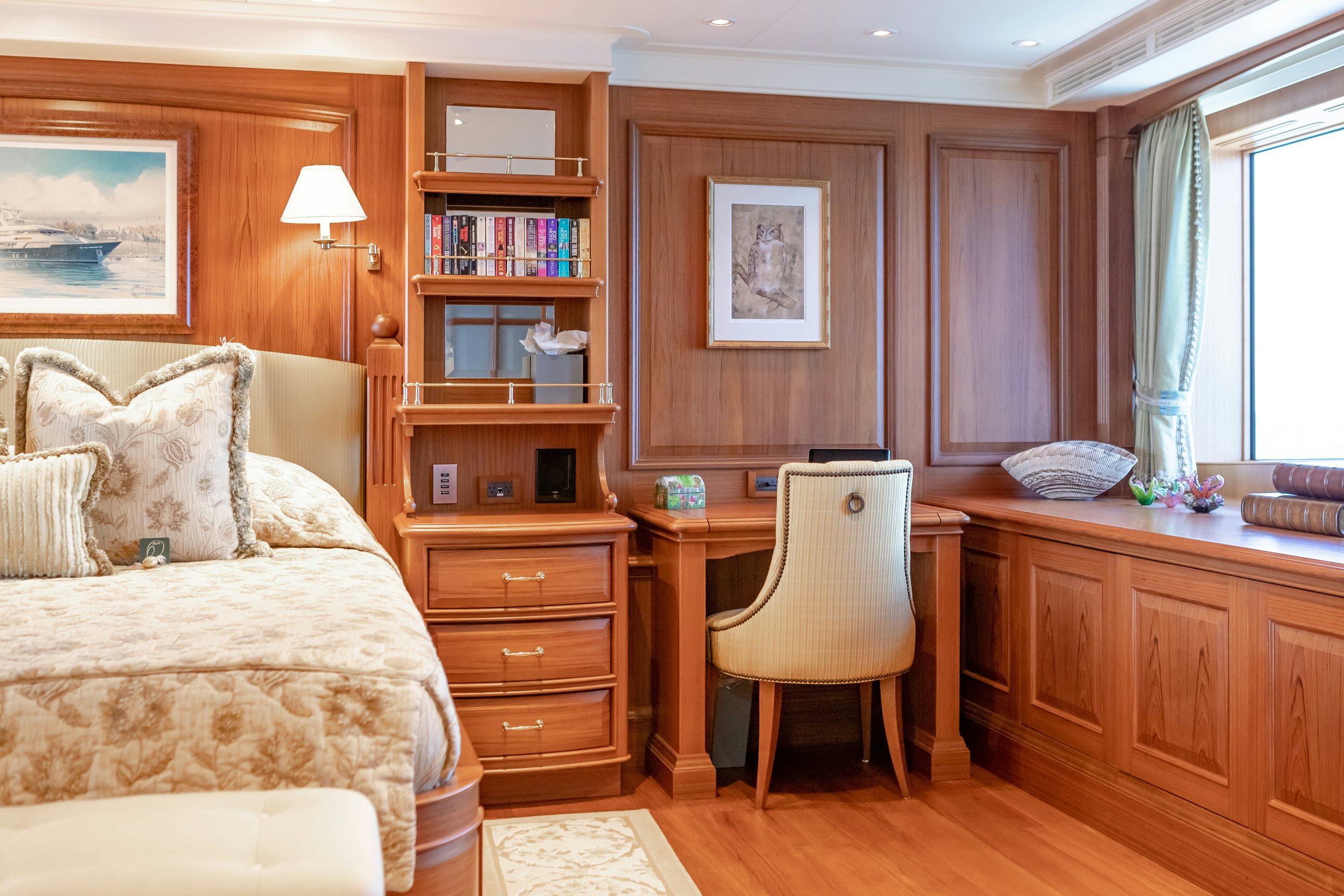 a bedroom with a bed and a desk aboard SHADOWL Yacht for Sale