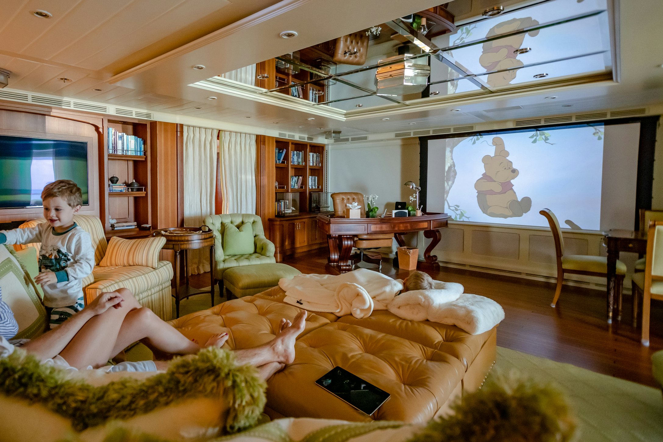 a boy sitting on a couch aboard SHADOWL Yacht for Charter