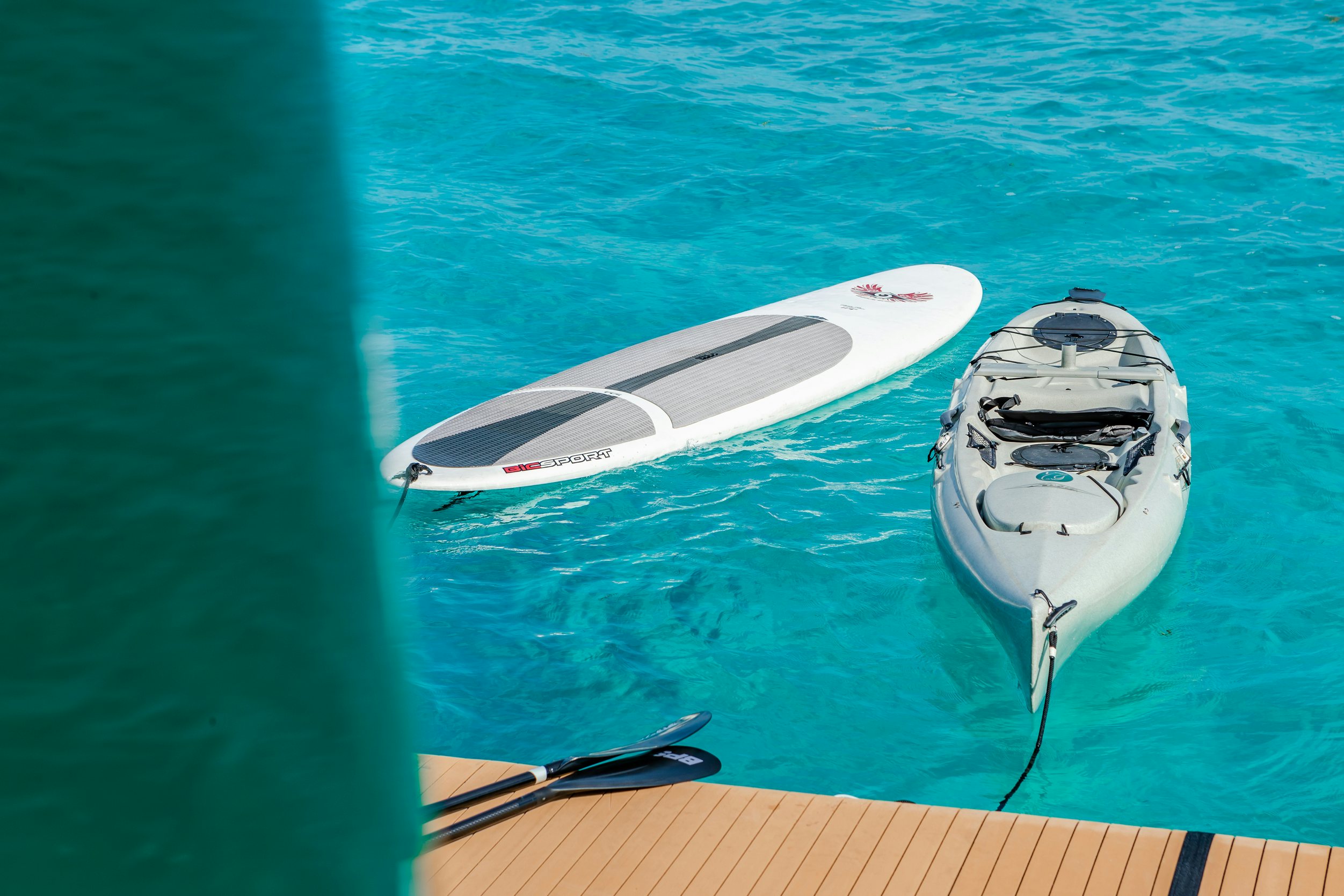 a white surfboard in a pool aboard SHADOWL Yacht for Charter