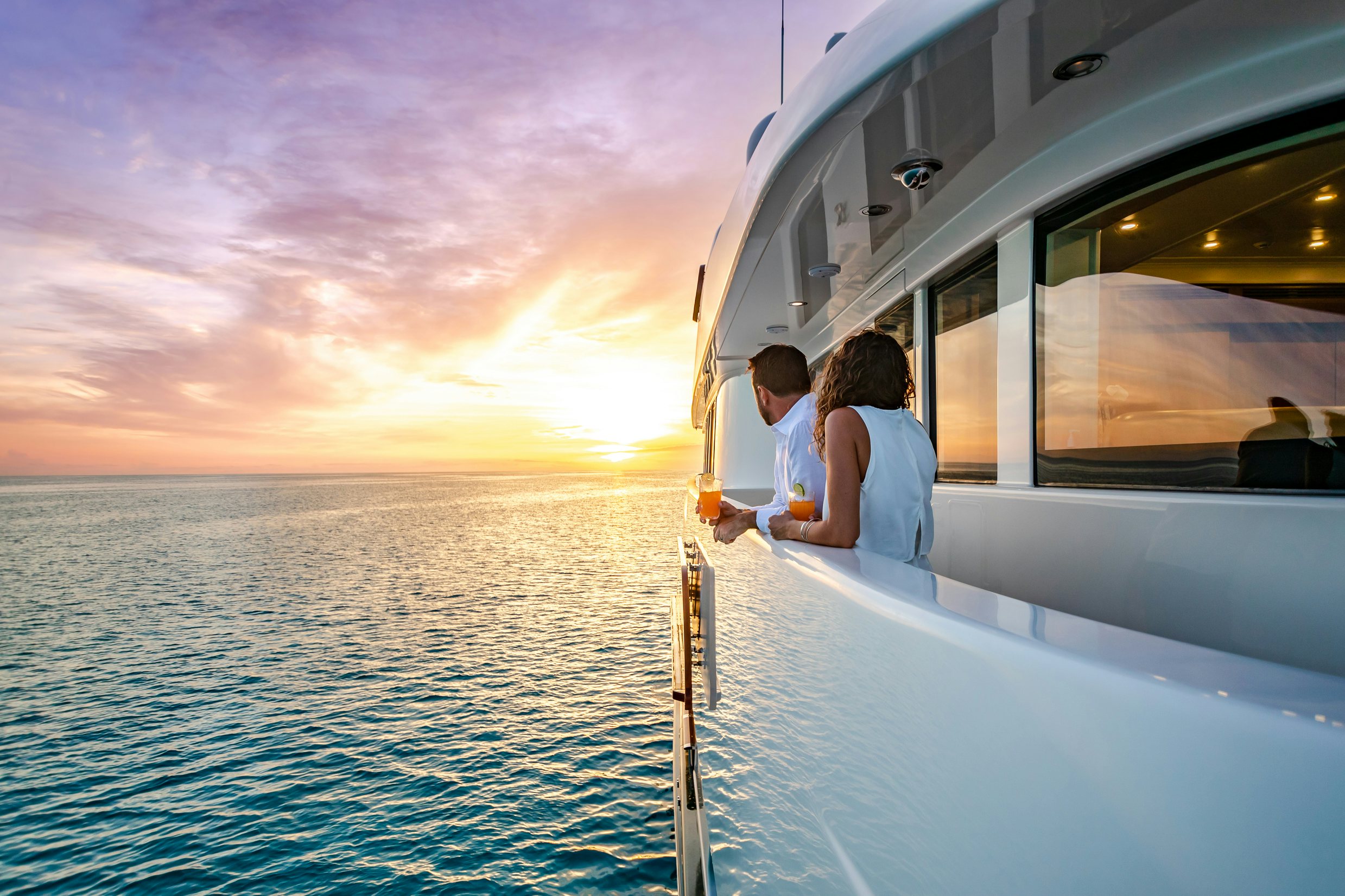 a man and woman sitting on a boat in the water aboard SHADOWL Yacht for Charter