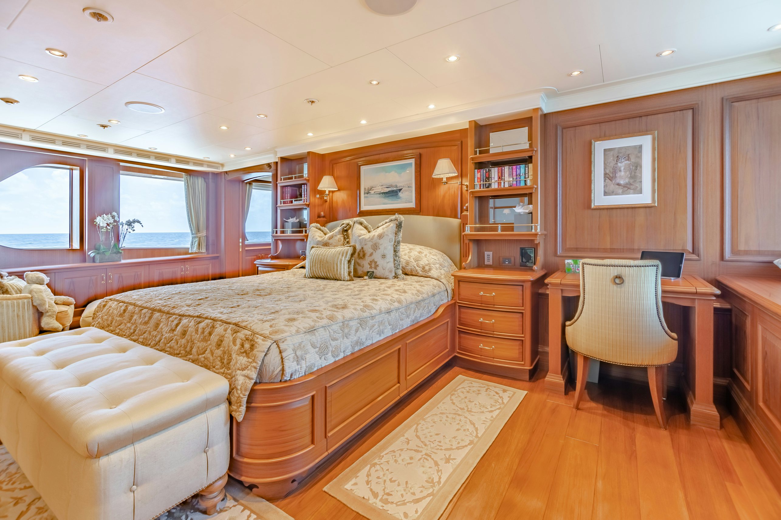 a bedroom with a bed and a bookcase aboard SHADOWL Yacht for Charter