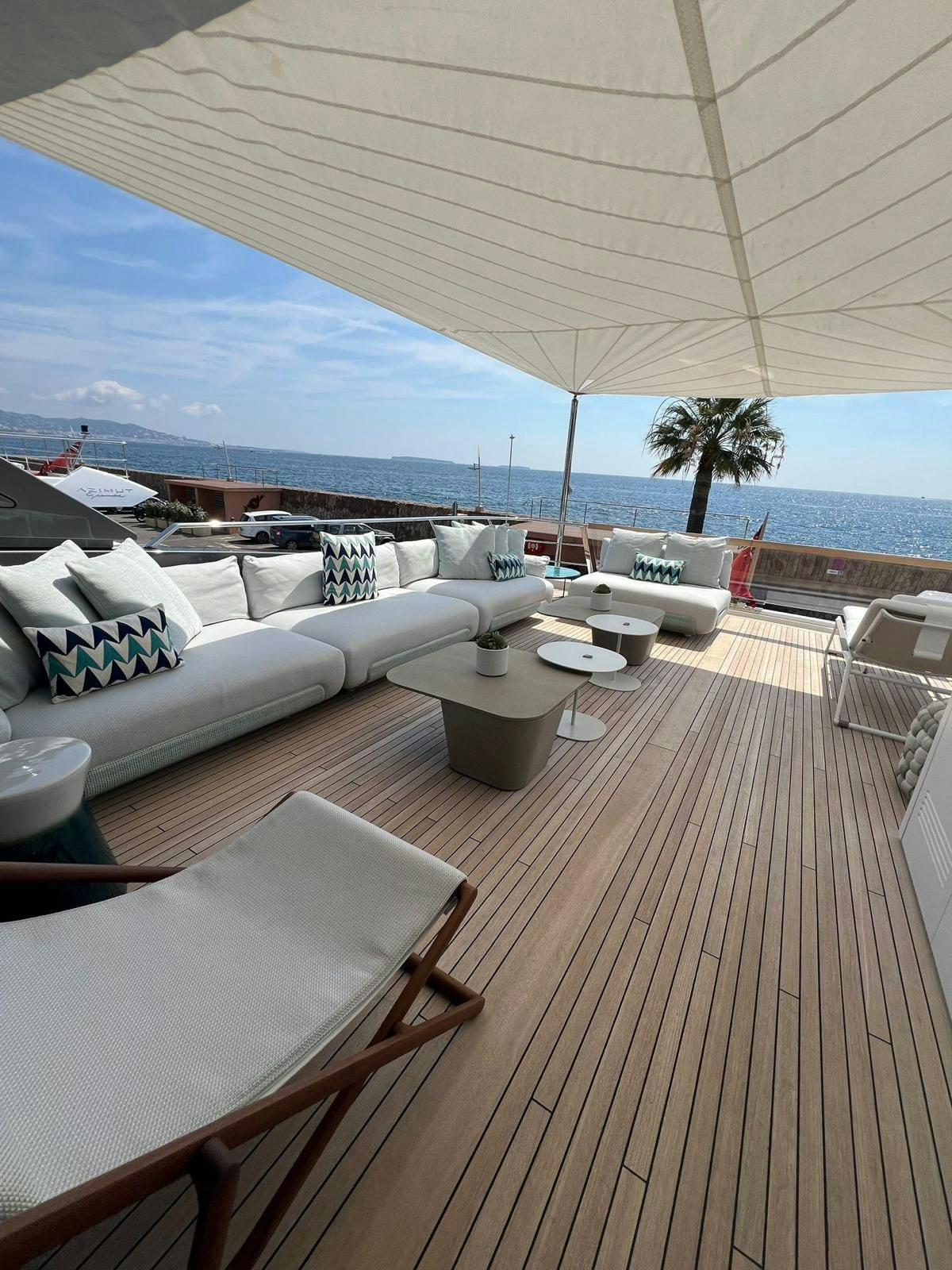 a deck with a view of the ocean and a beach aboard MAREA Yacht for Sale