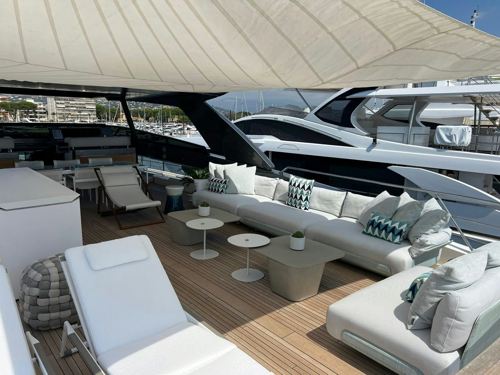 a yacht with a lounge chair and tables aboard MAREA Yacht for Sale