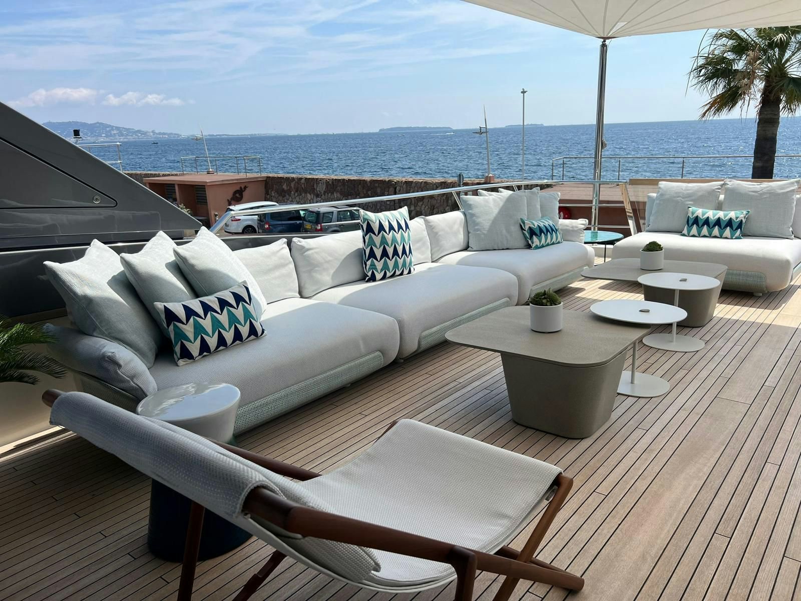 a patio with a couch and a table and chairs on it aboard MAREA Yacht for Sale