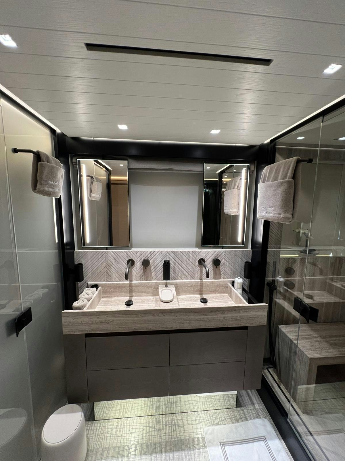 a bathroom with a large mirror aboard MAREA Yacht for Sale