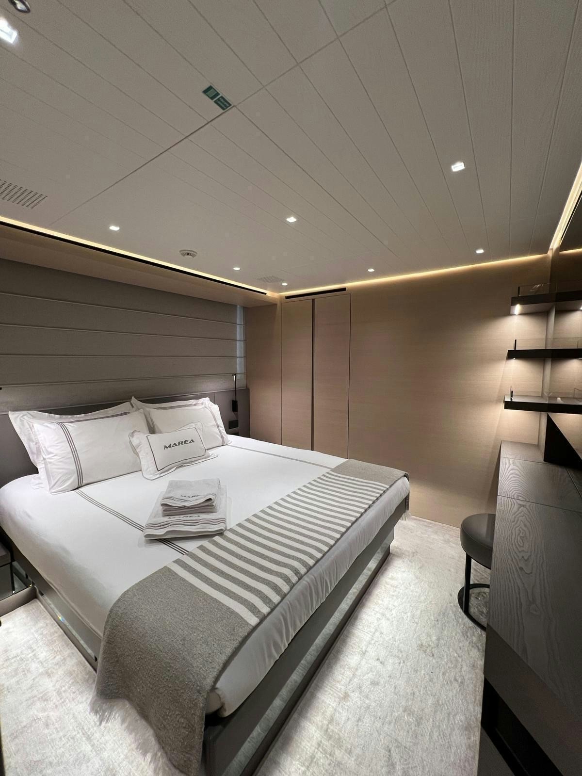 a bed with white sheets aboard MAREA Yacht for Sale