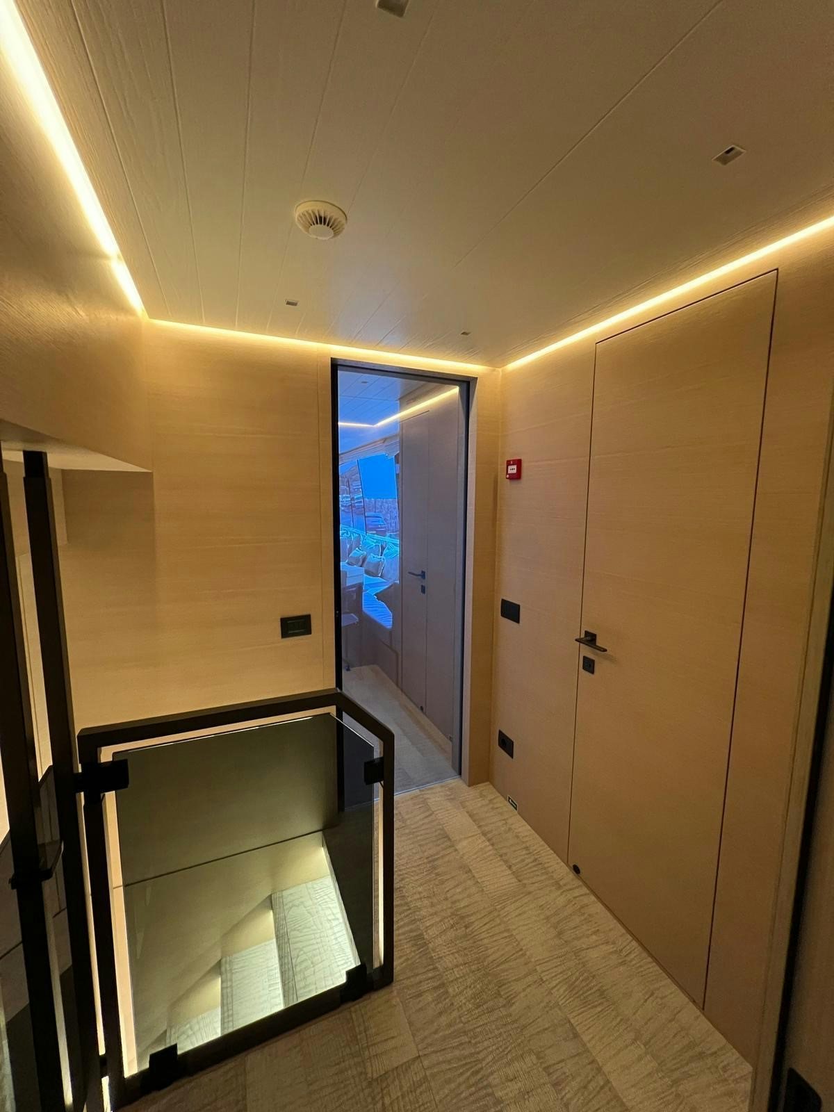 a hallway with a glass door aboard MAREA Yacht for Sale