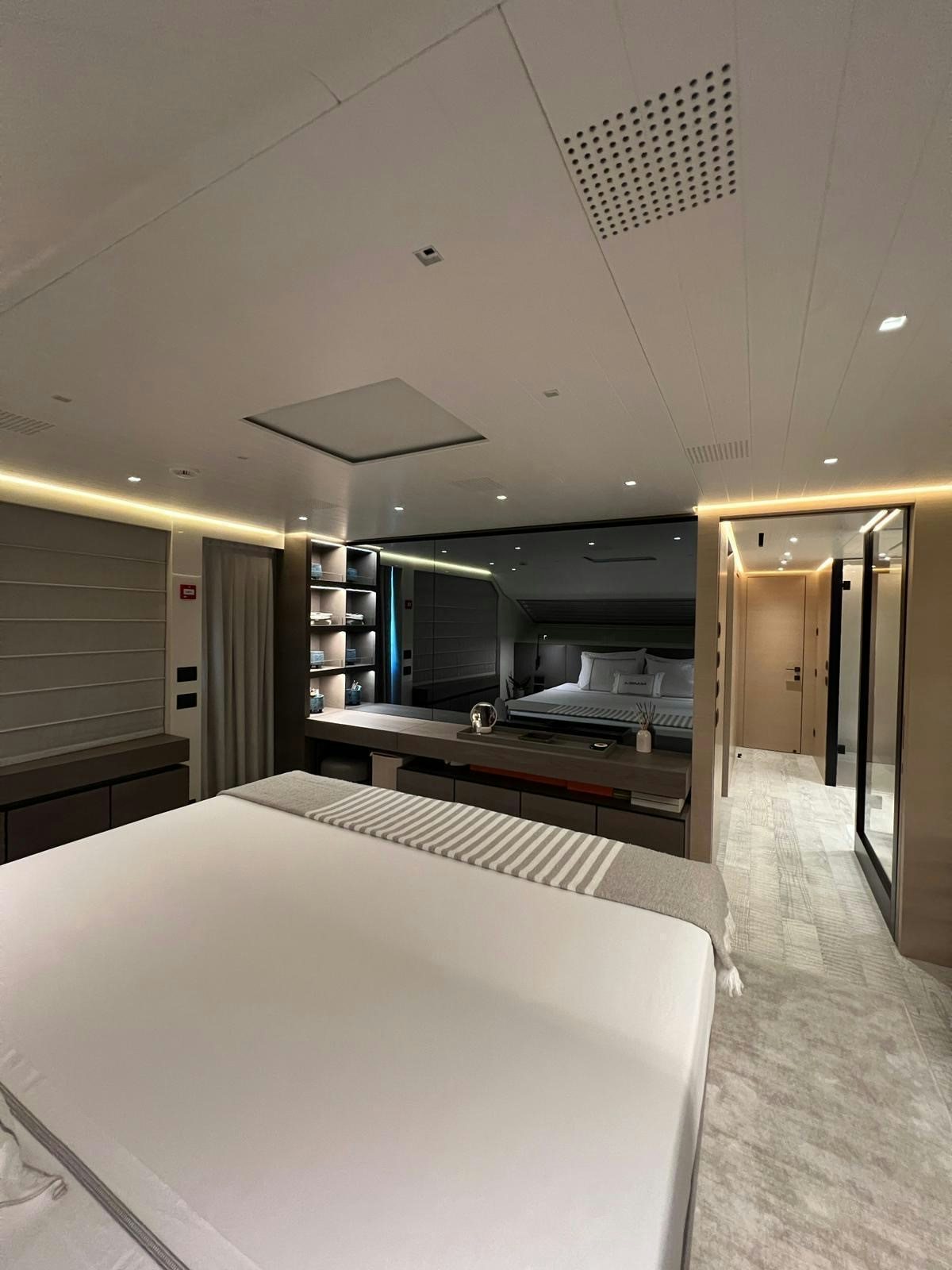 a room with a bed and a desk aboard MAREA Yacht for Sale