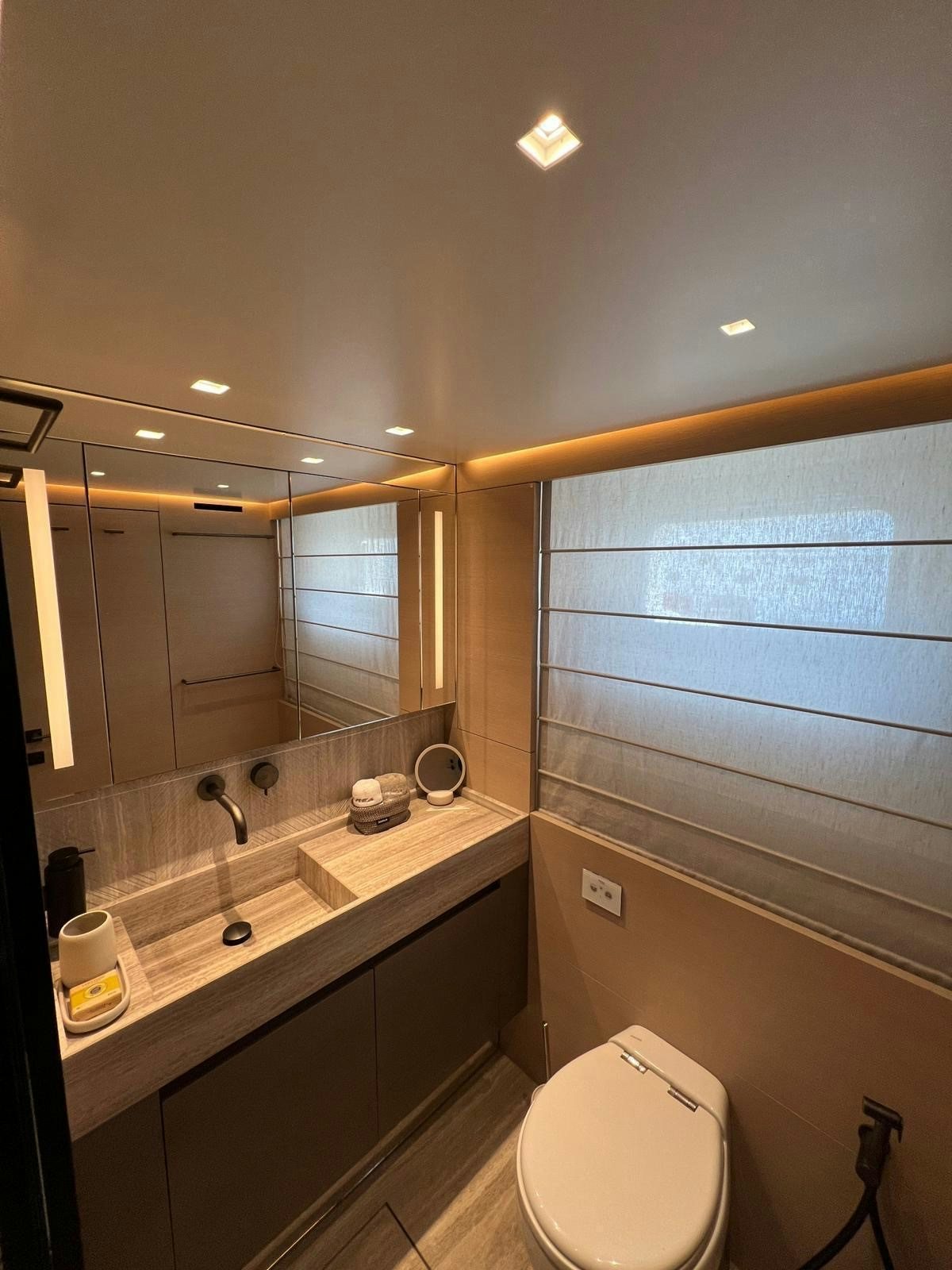 a bathroom with a mirror and a sink aboard MAREA Yacht for Sale
