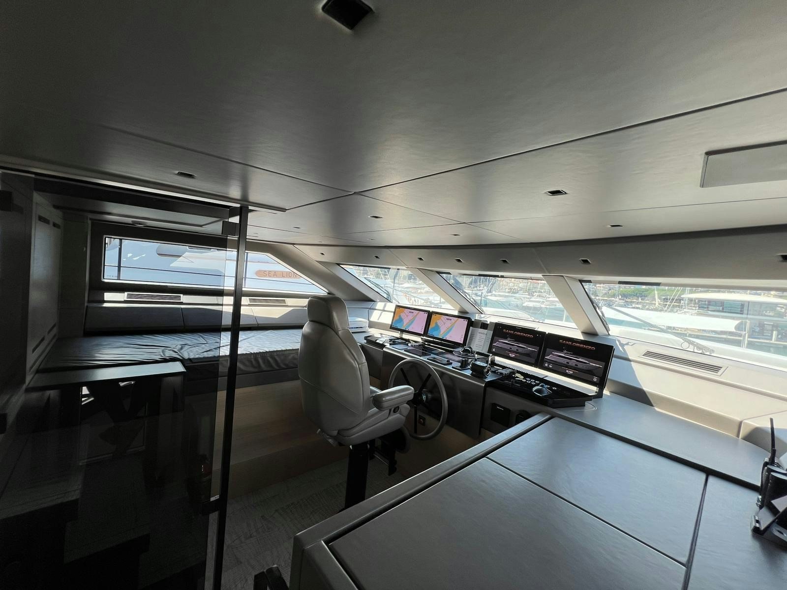 a person sitting in a chair in a room with a window aboard MAREA Yacht for Sale