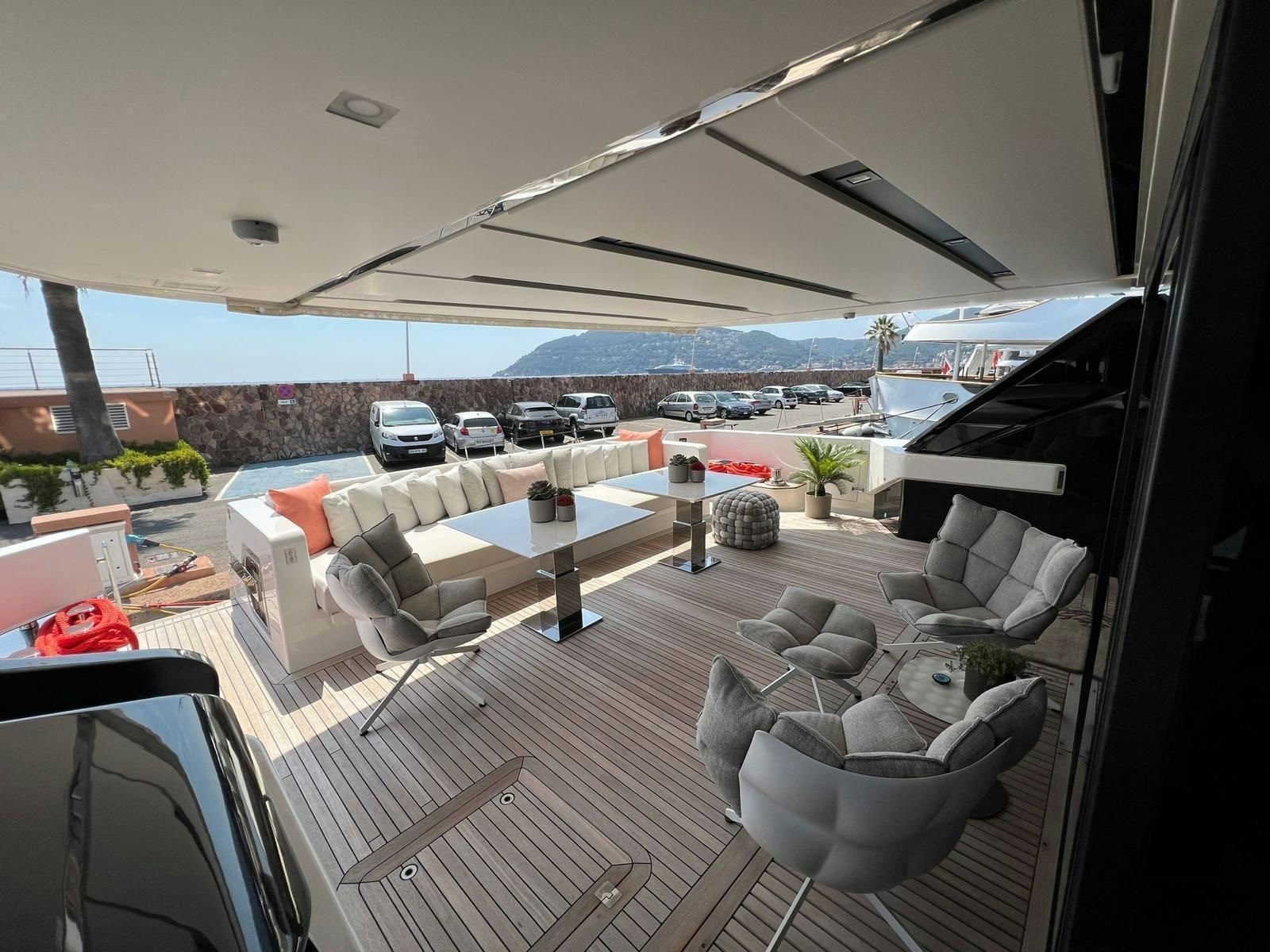 a view of a patio with a group of chairs and a table and a body of water in aboard MAREA Yacht for Sale