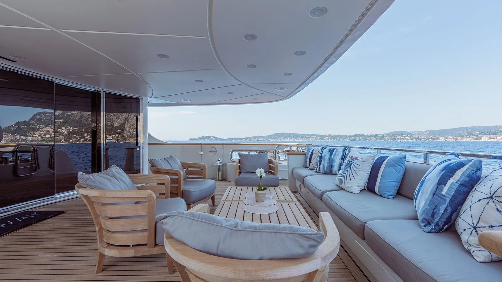 a large living room with a view of the ocean aboard AWAY Yacht for Charter