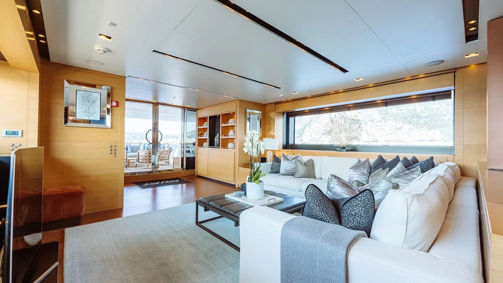 a living room with a large window aboard AWAY Yacht for Charter