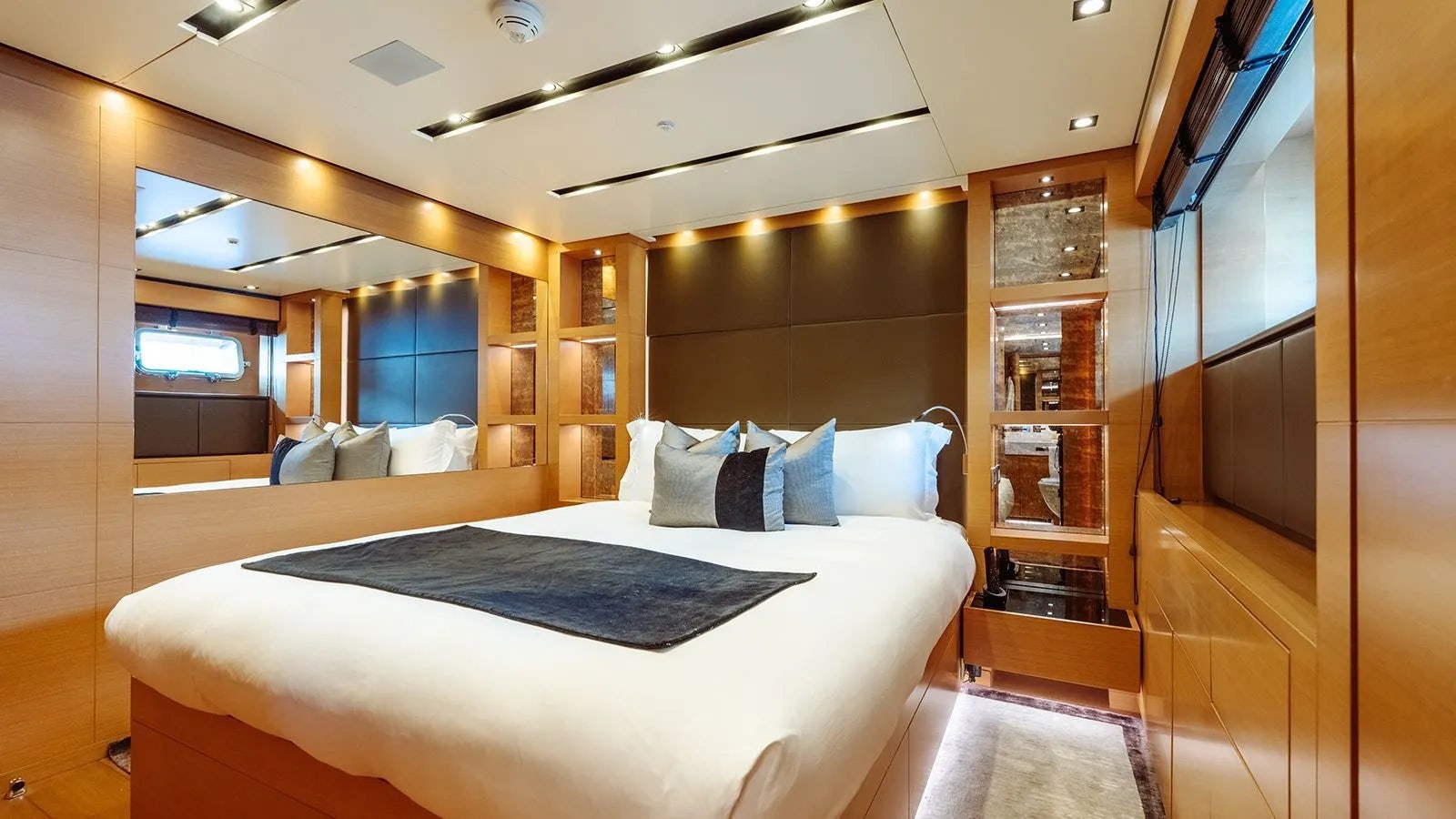 a room with a bed and a mirror aboard AWAY Yacht for Charter